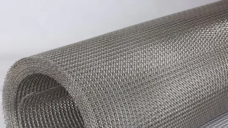 Plain weave stainless steel wire mesh showing uniform square apertures — ideal for explaining mesh count versus micron rating