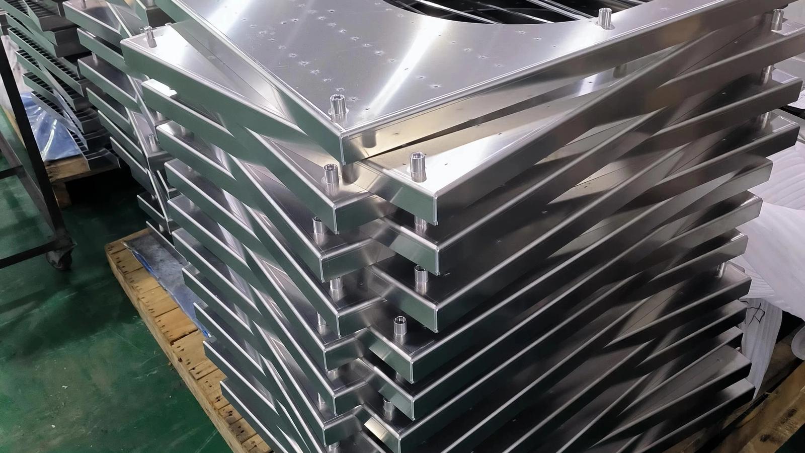 OEM stainless steel wire mesh filter baskets and screen assemblies in various sizes on a production table