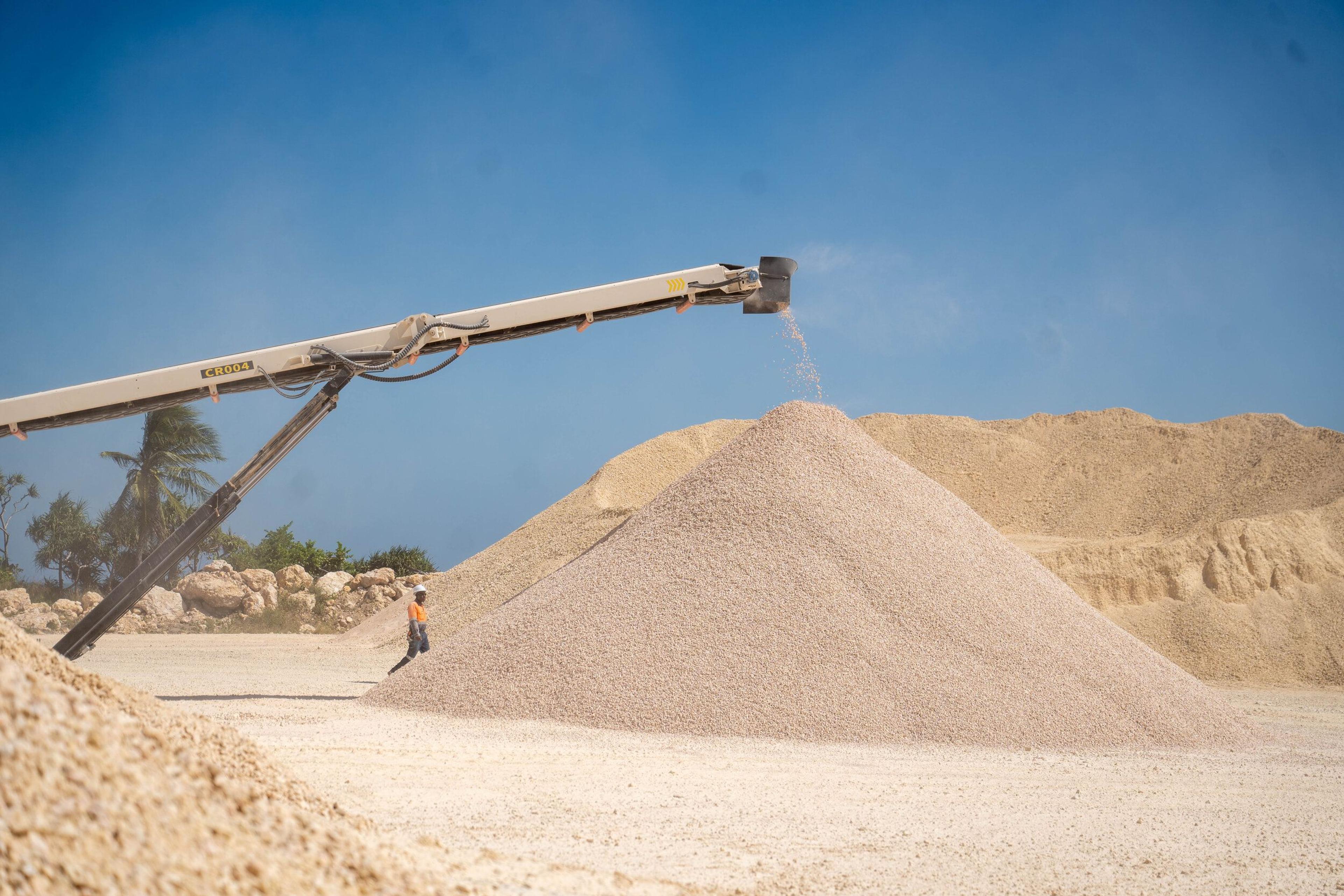 A conveyor discharging aggregate onto a stockpile