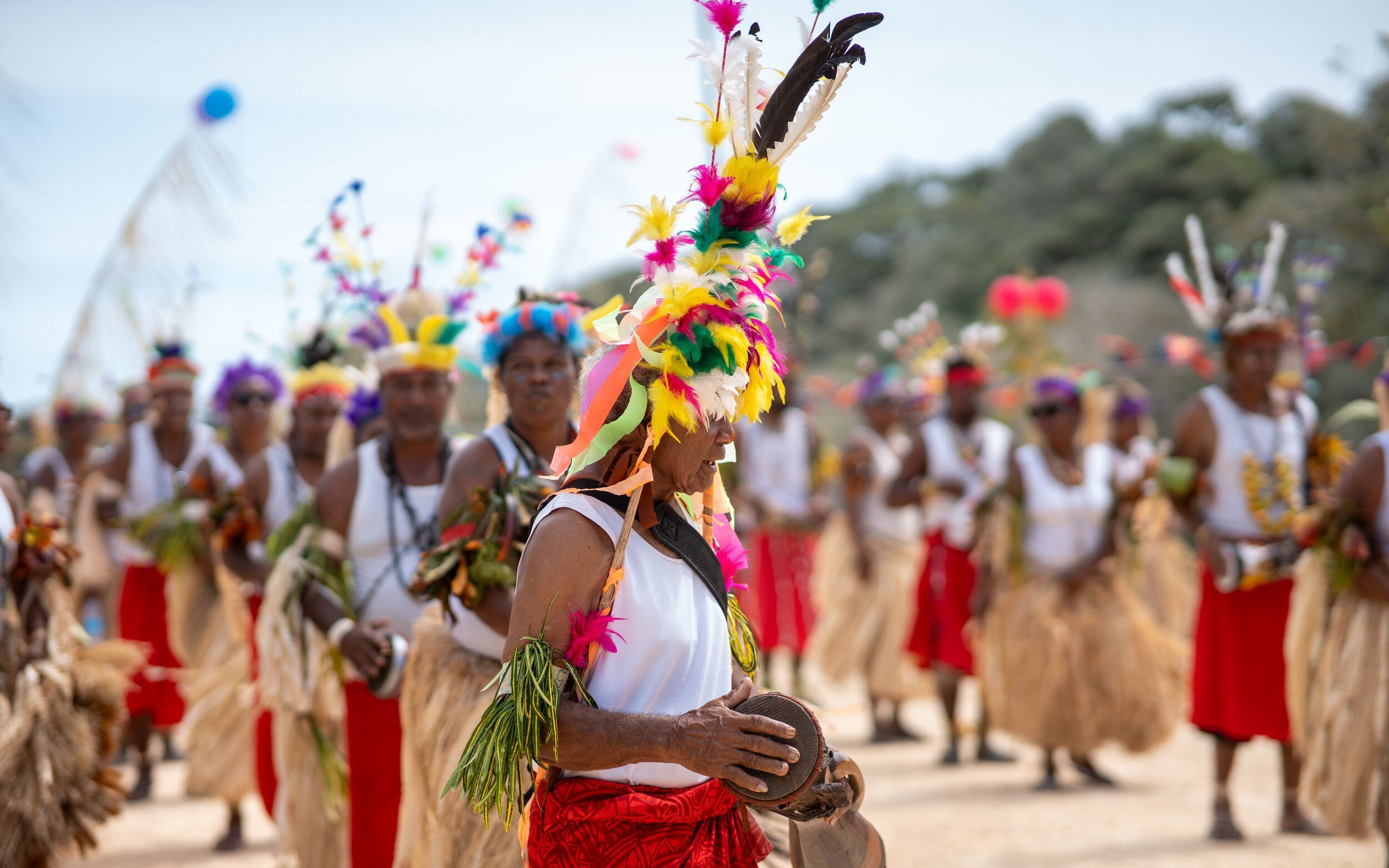Papua New Guinean dancers in traditional dress at a Pacific Lime and Cement community event