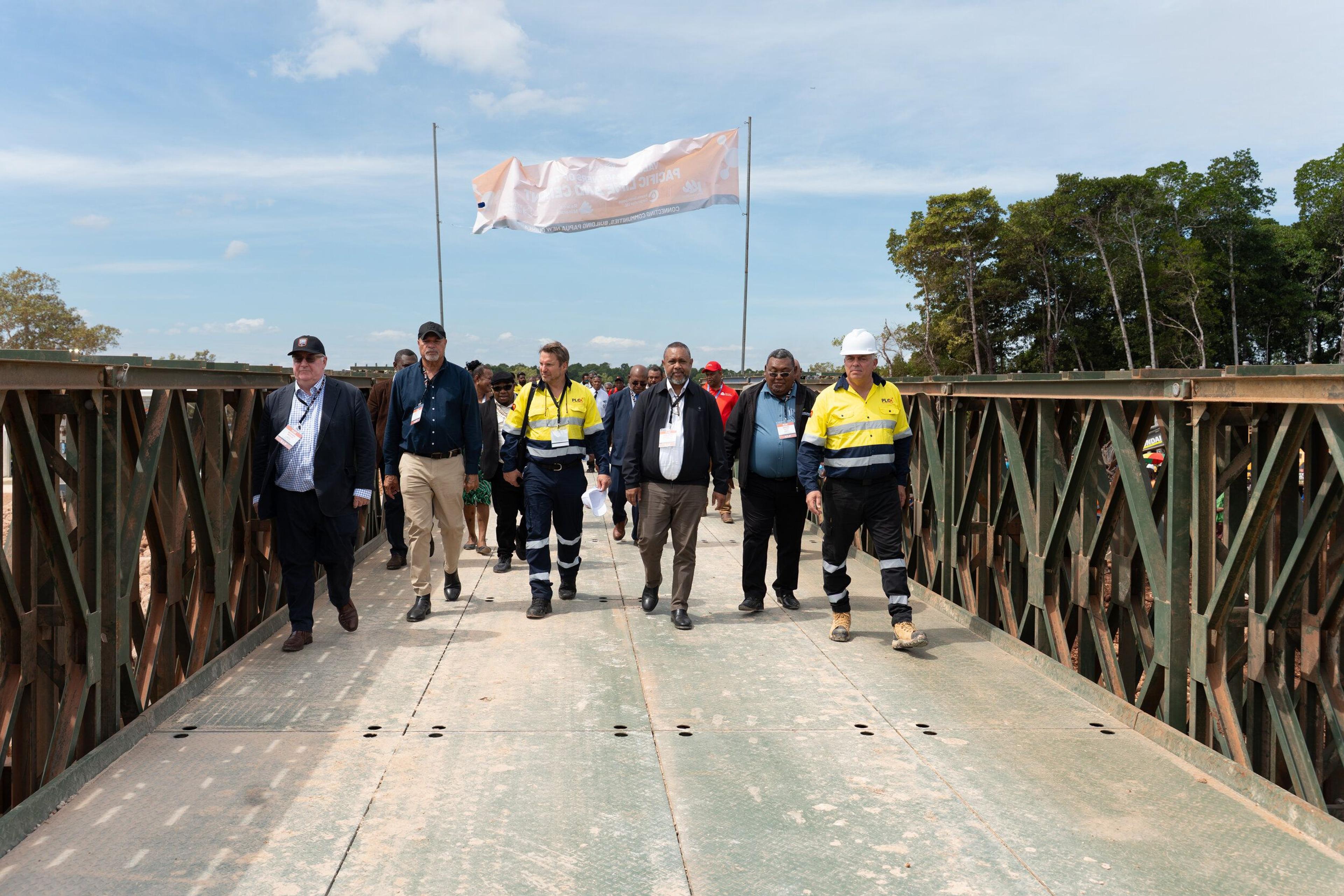 Government officials and Pacific Lime and Cement representatives crossing the new bridge
