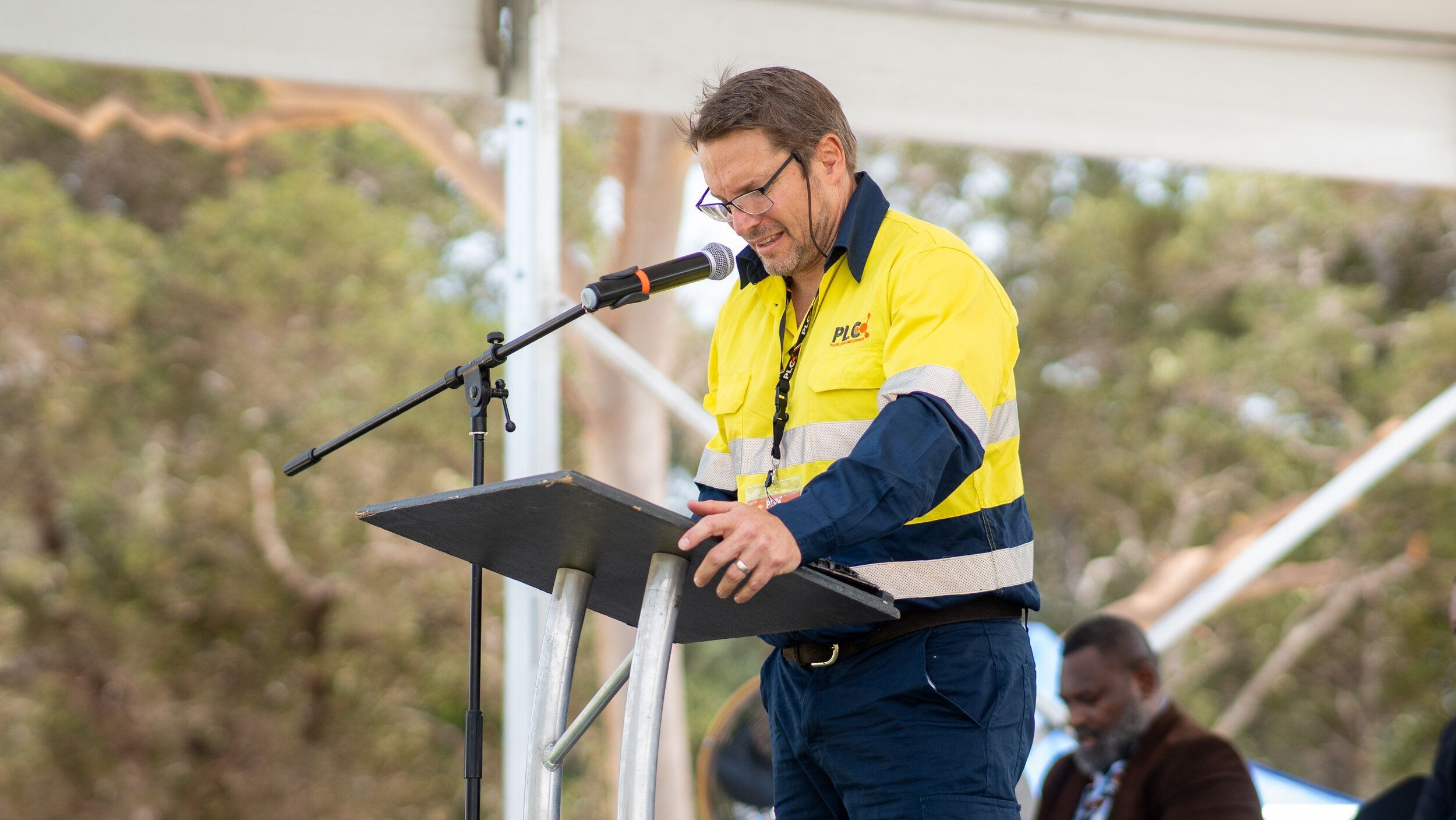 A Pacific Lime and Cement executive addressing an audience on site
