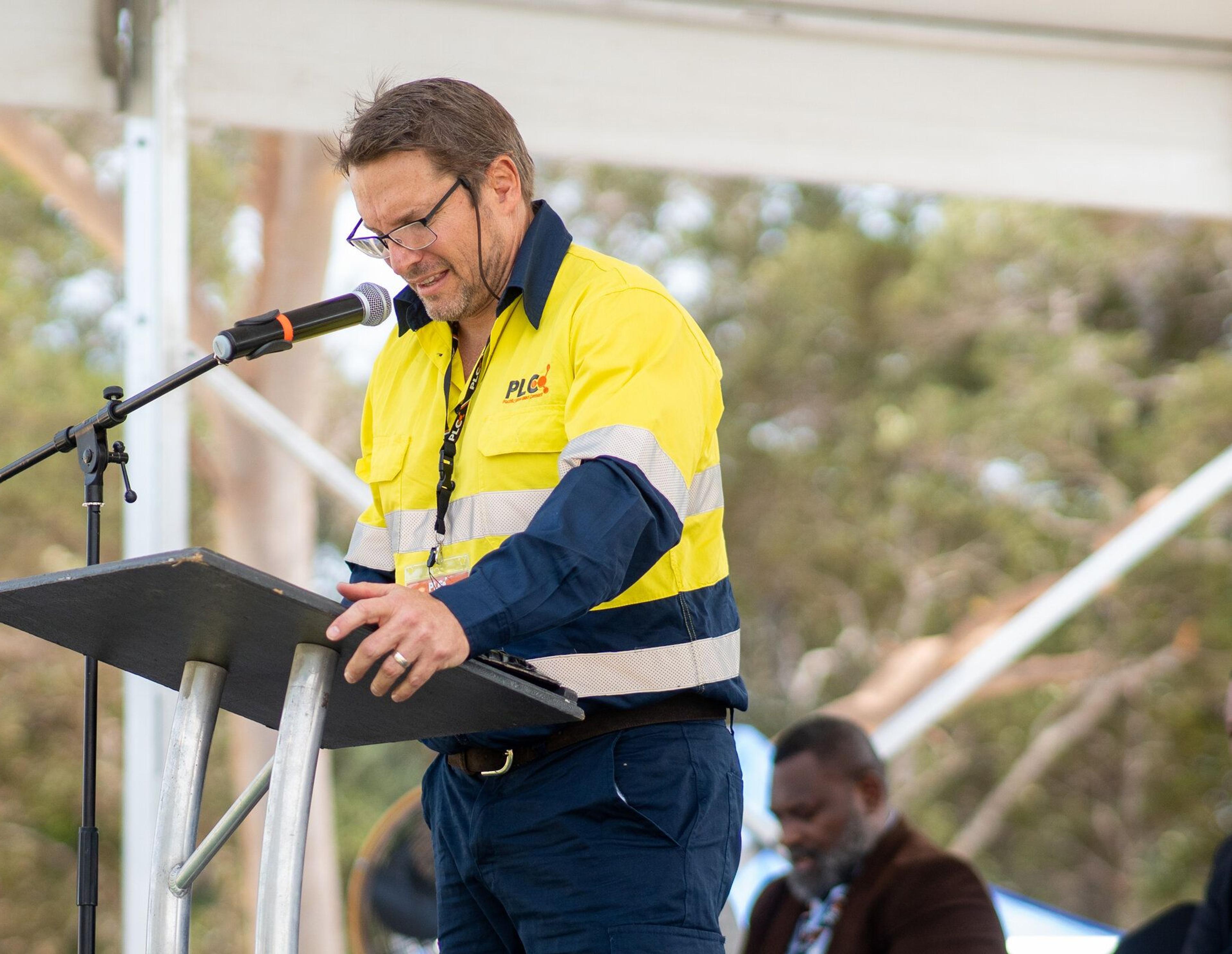 A Pacific Lime and Cement executive addressing an audience on site
