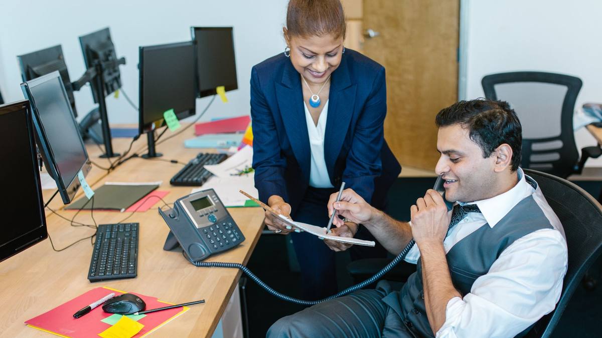 A group reviewing work around a table in an office