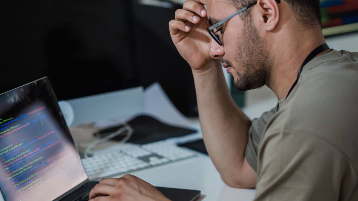A developer focused on code at a desk