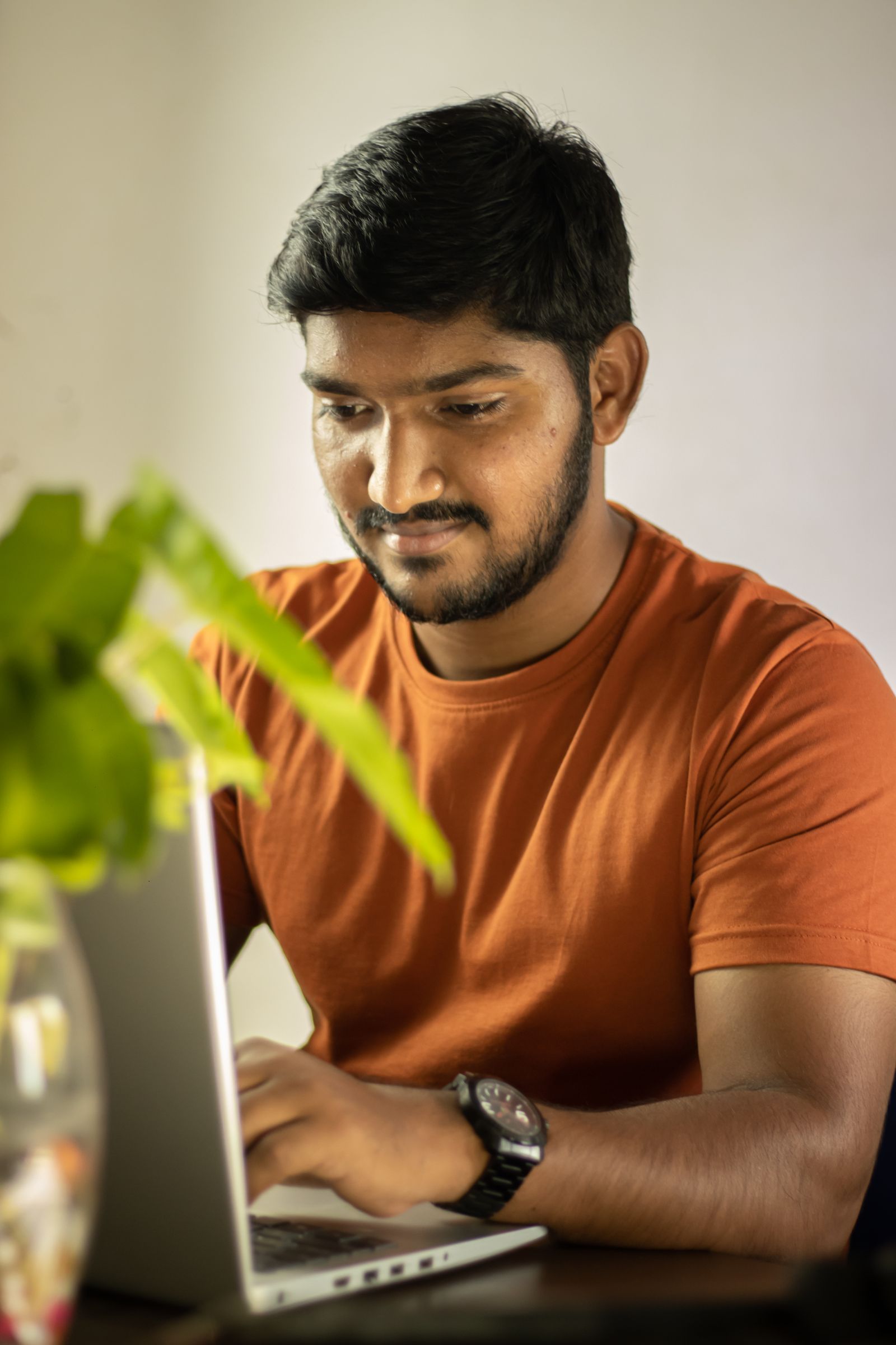 A professional working intently at a laptop