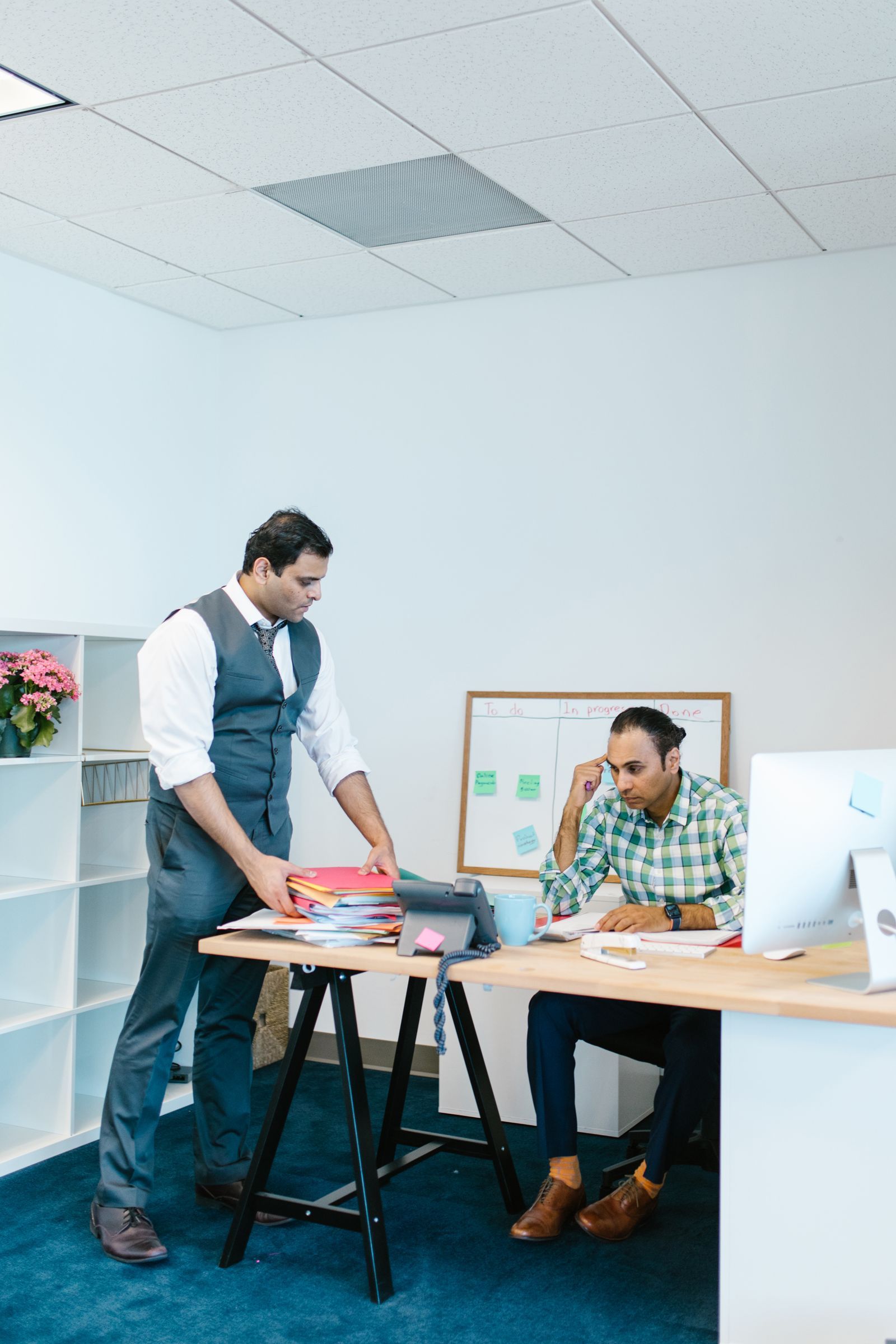 Two professionals in discussion across a desk