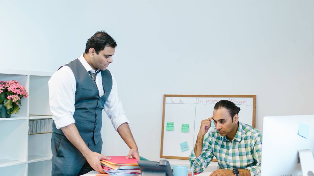 Two professionals in discussion across a desk