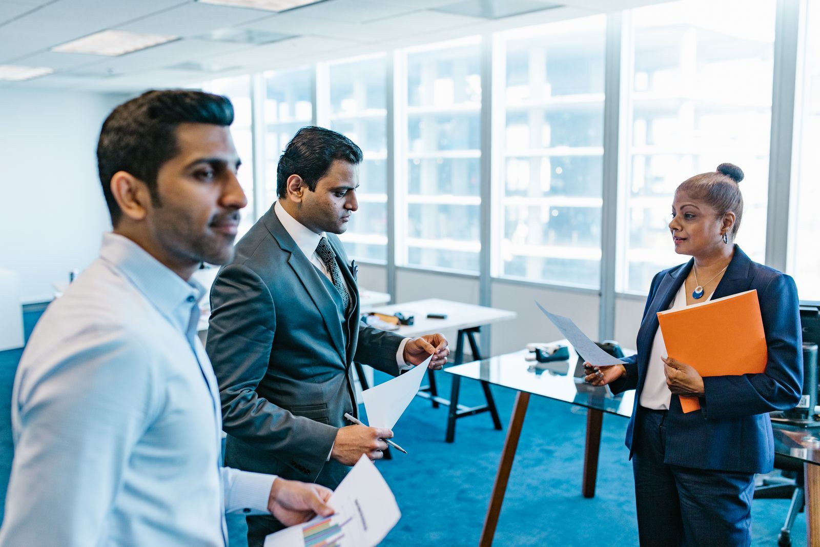 Colleagues reviewing documents together in an office