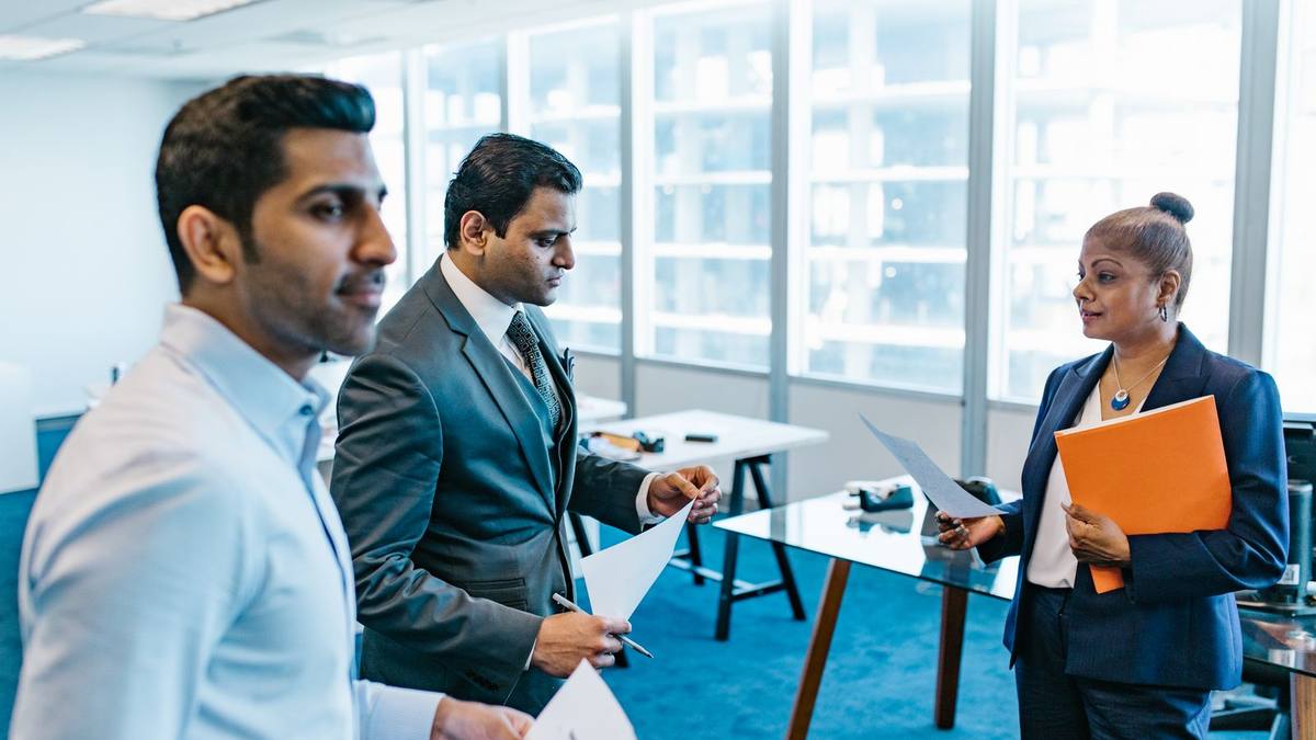 Colleagues reviewing documents together in an office