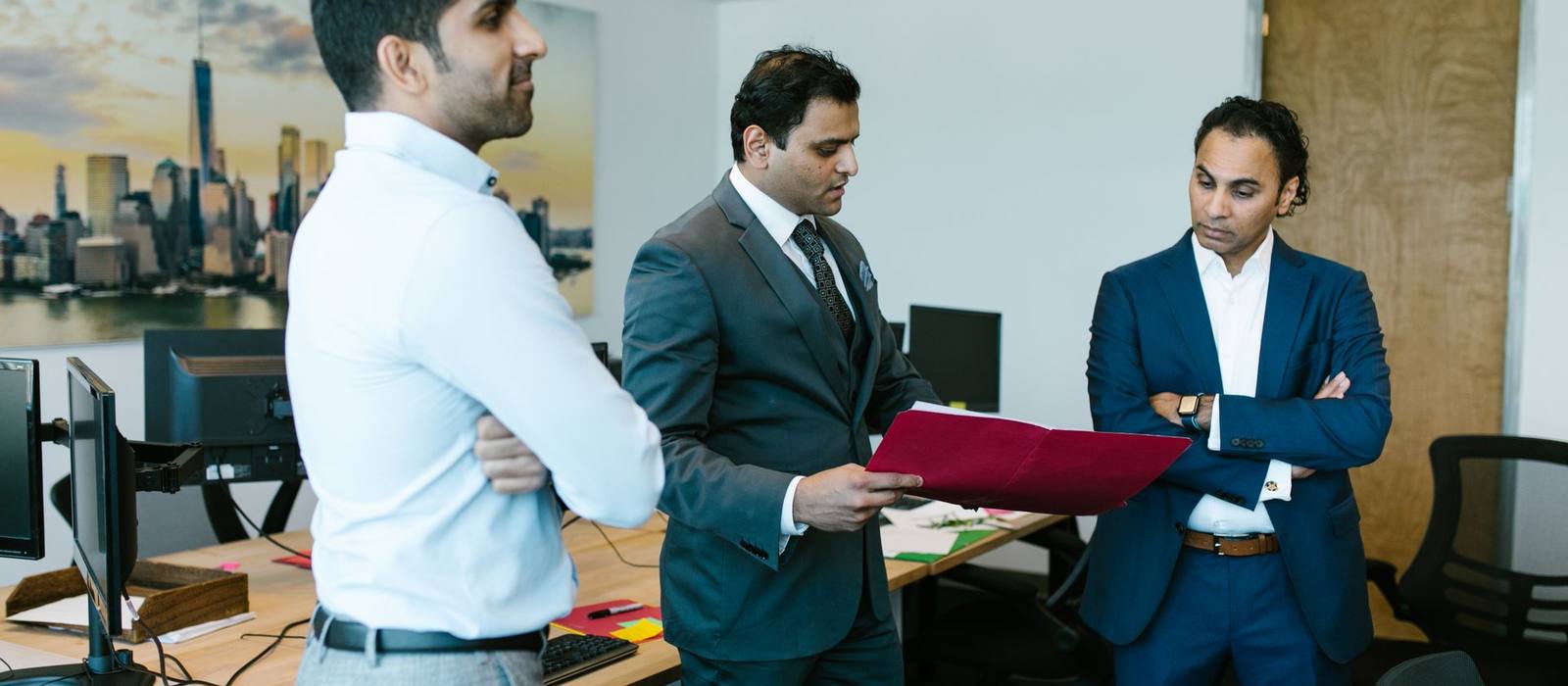 Colleagues reviewing documents together in an office