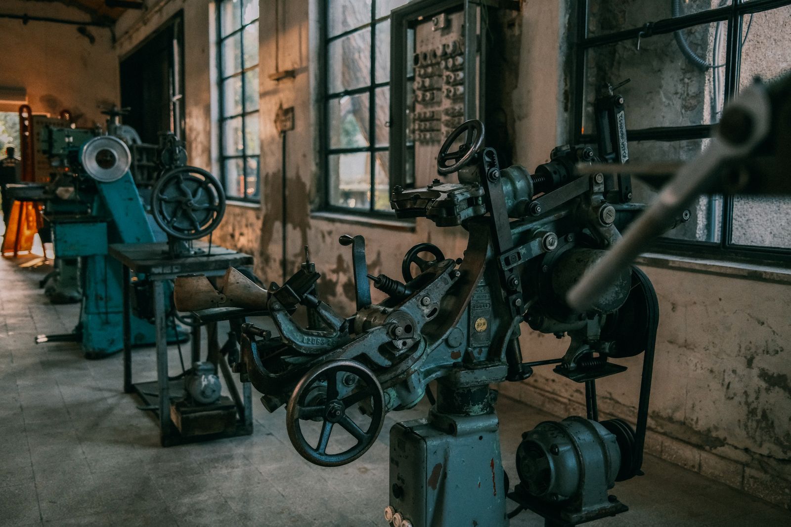 Disused machinery in an empty industrial workshop