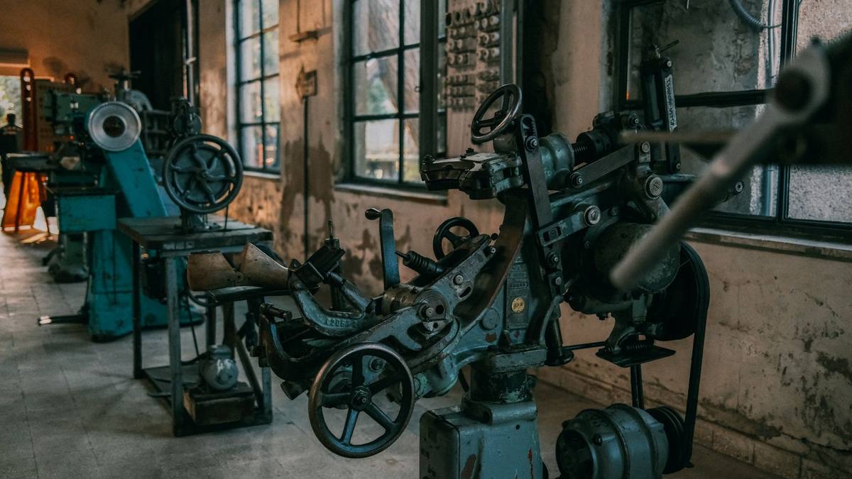 Disused machinery in an empty industrial workshop