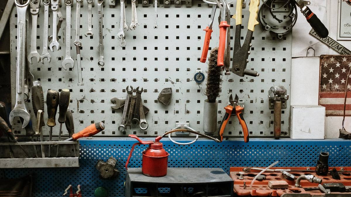 A power tool and hand tools arranged on a workbench
