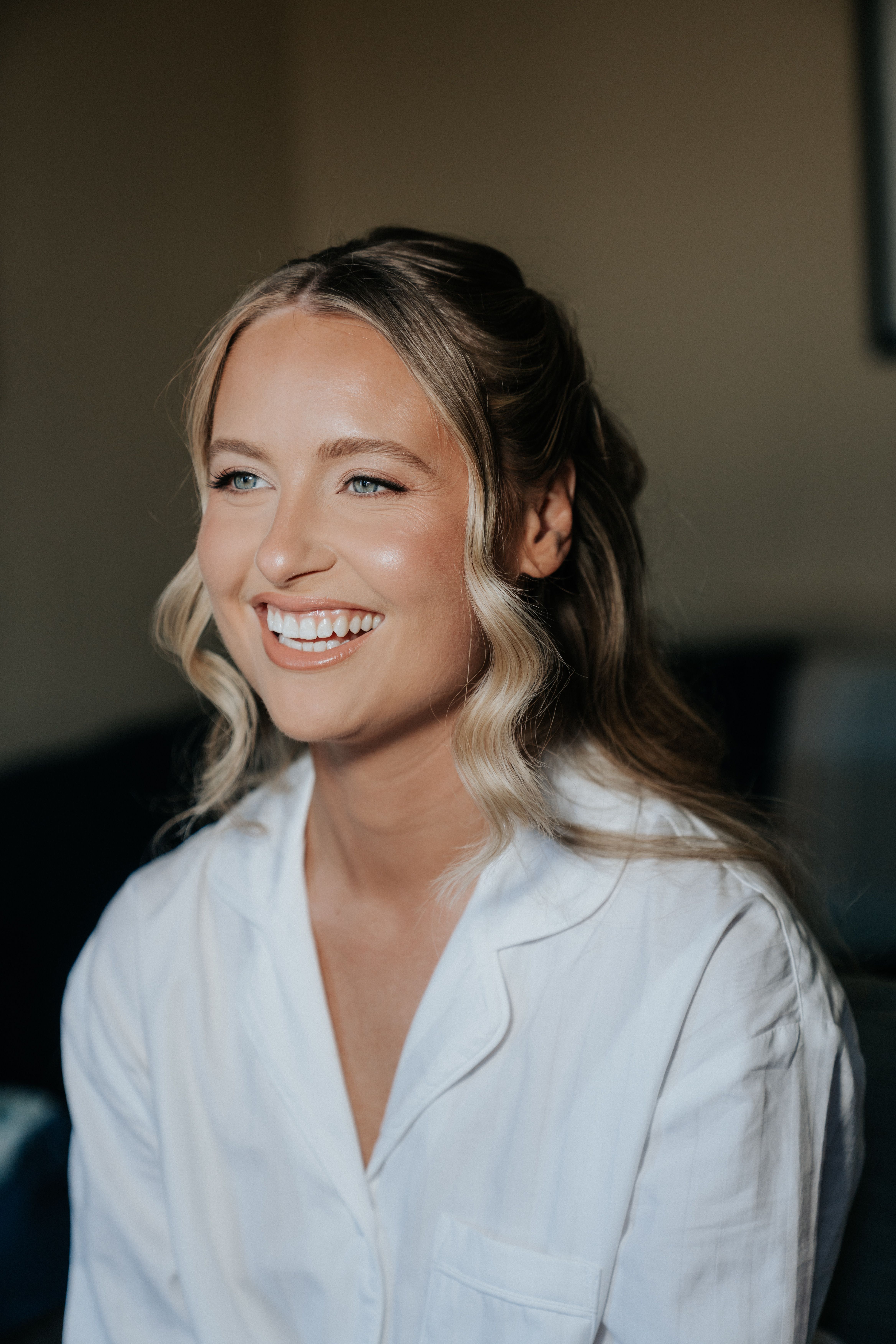 bride smiling at her makeup