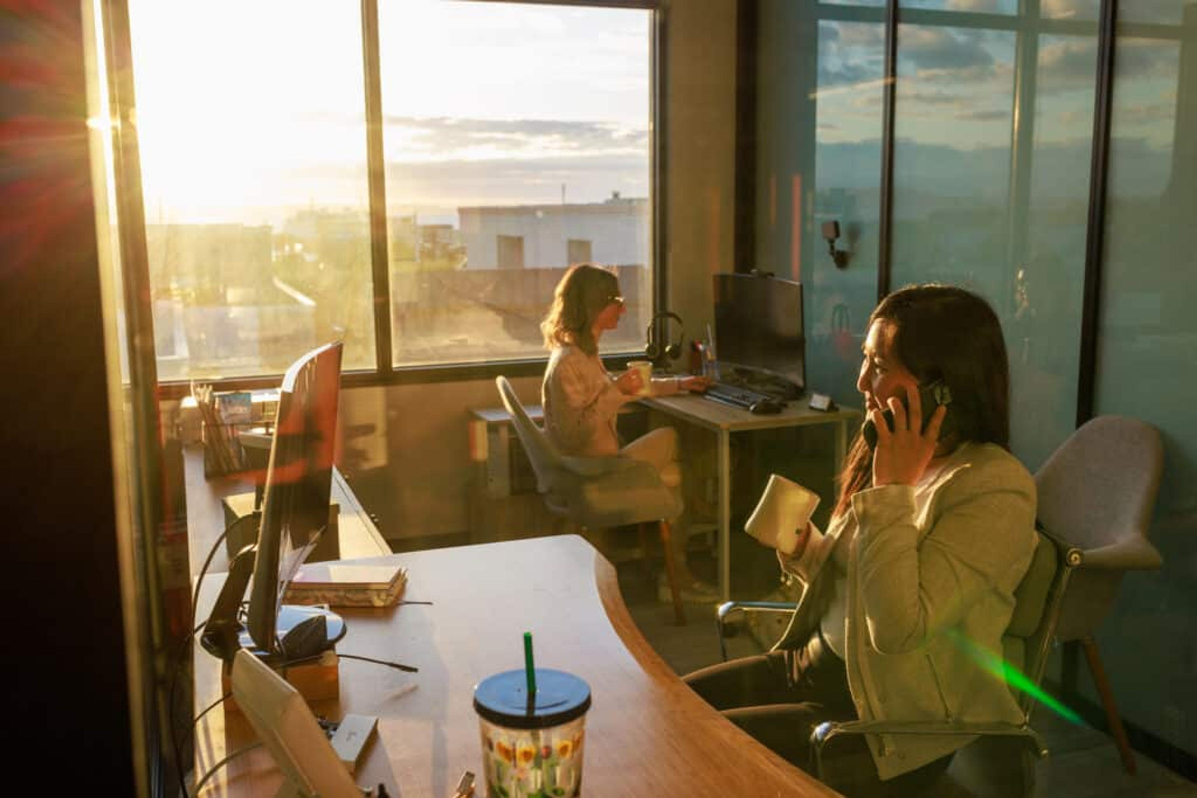 Two people on phone calls in private offices in Edmonds, WA