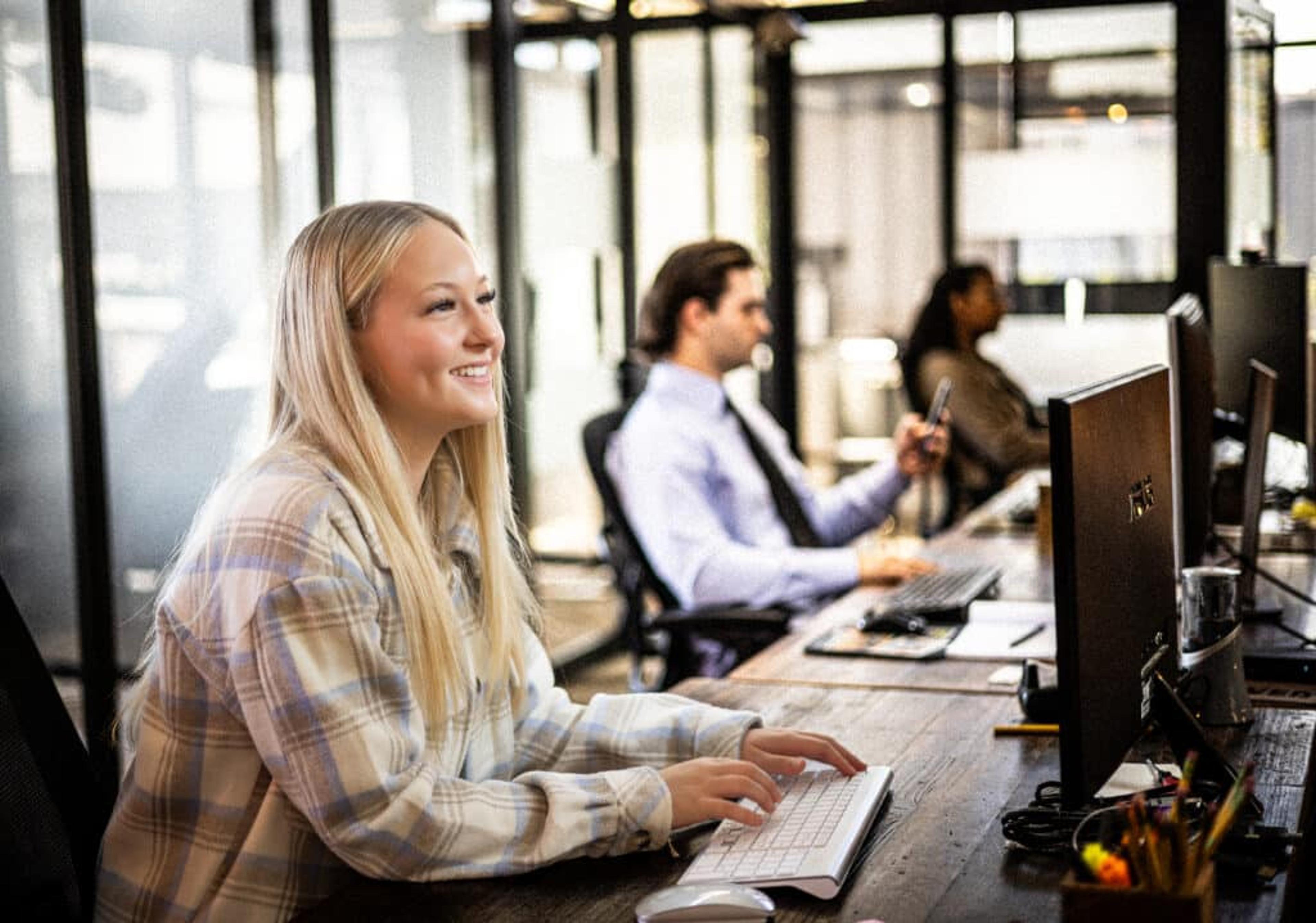 Woman smiling at dedicated desk in Edmonds, WA