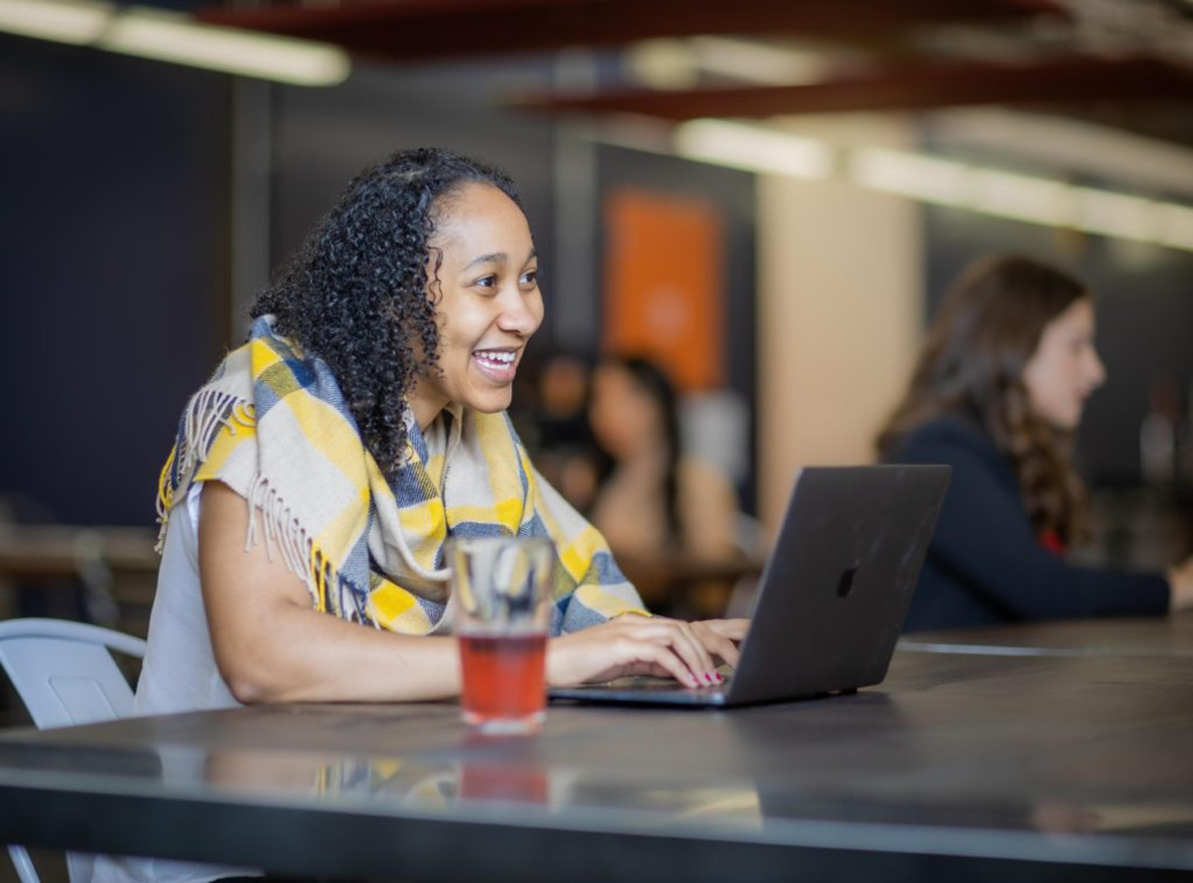 Woman smiling as she types