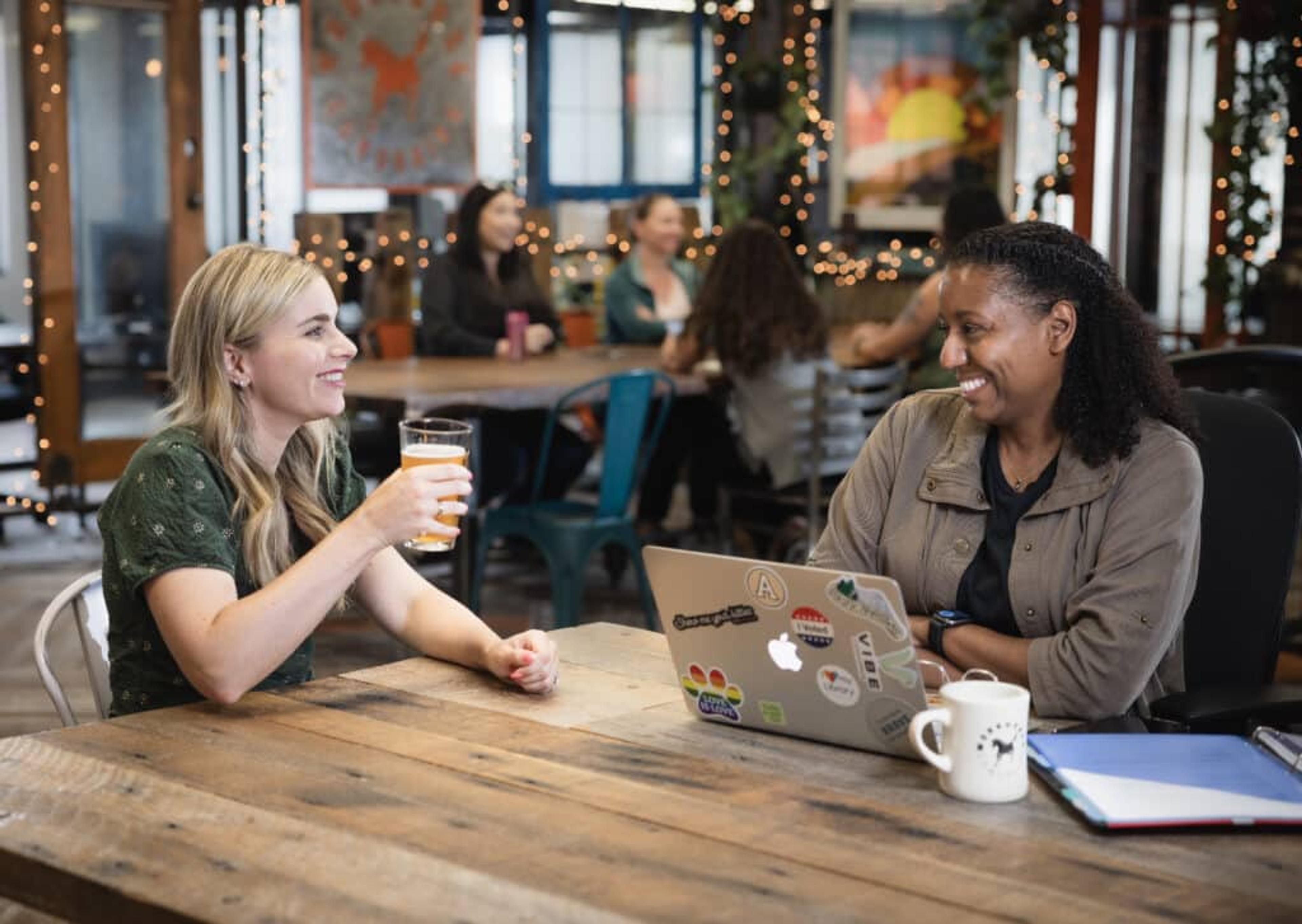two ladies having a conversation at a table