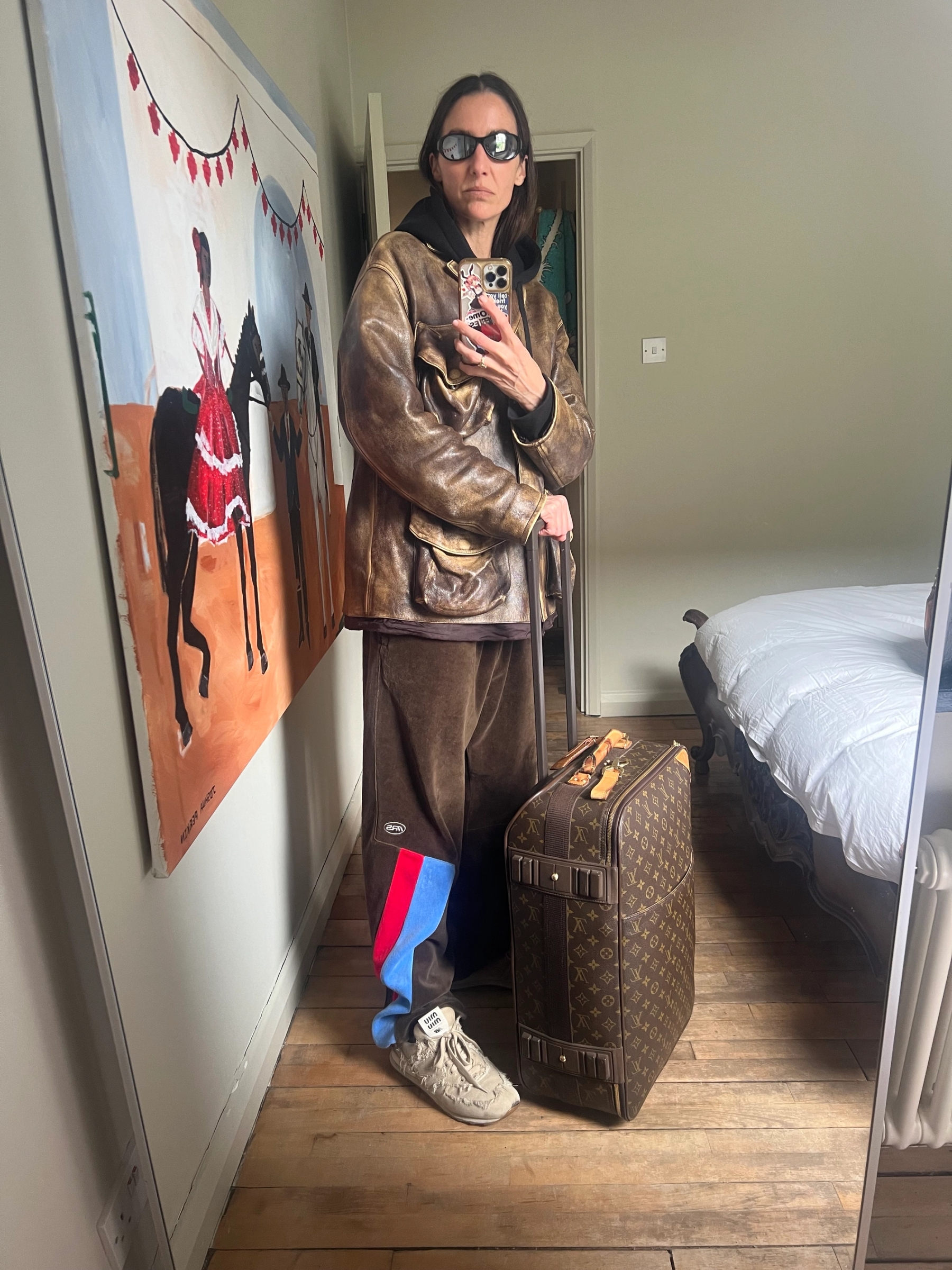 Bag Louis Vuittton, Jacket Miu Miu, Hoodie Nike, Trousers Martine Rose X Supreme, Shoes Miu Miu X New Balance, Sunglasses Joseph