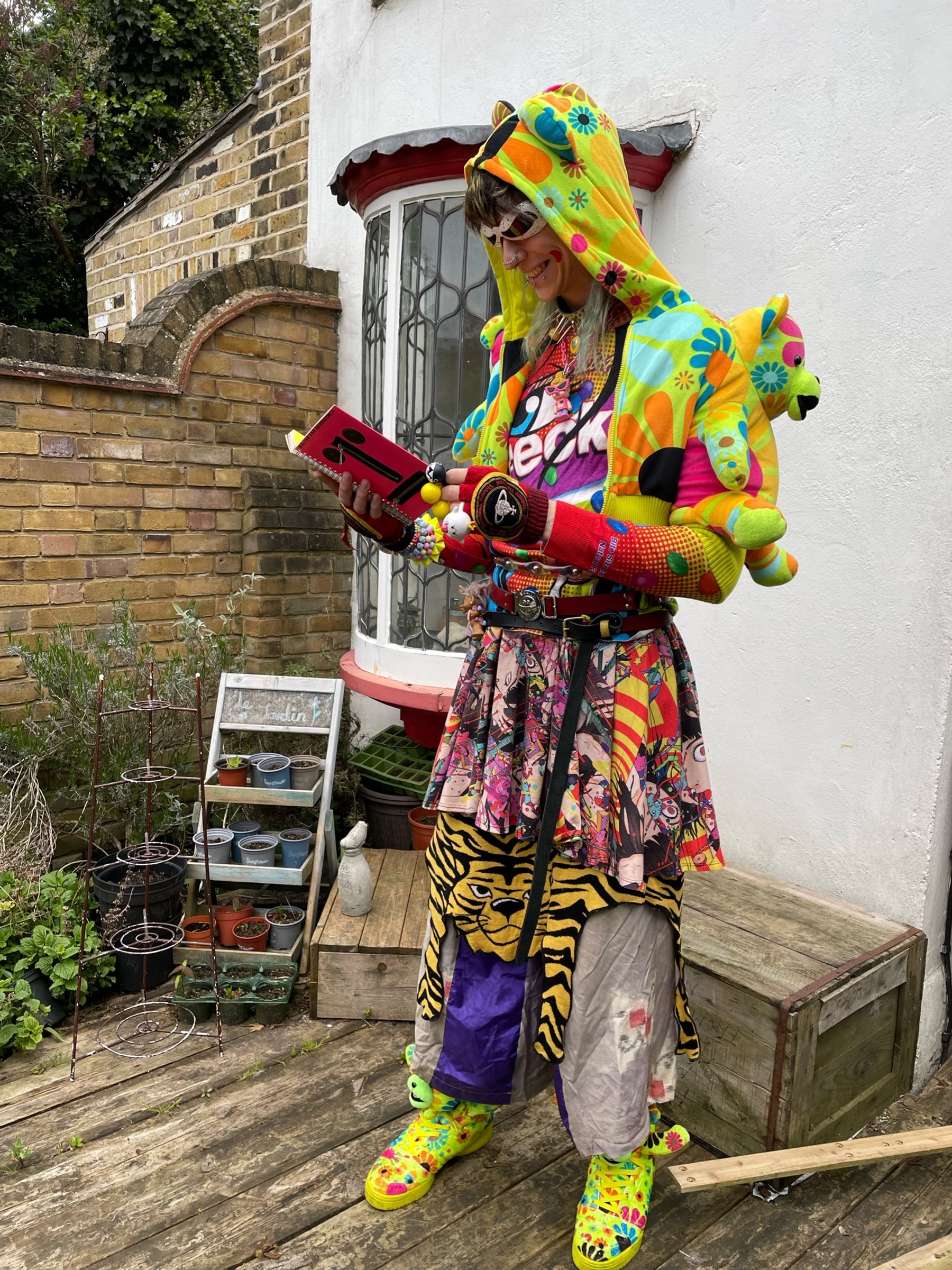 Sunglasses: Jeremy Scott x Linda Farrow - Jacket: Jeremy Scott x Adidas - Top: Moschino Couture x Ben Frost - Choker: @alexjustspat - Gloves: Vivienne Westwood - Belts: Michiko Koshino, Wild & Lethal Trash, Charles Jefferey Loverboy - Skirt: Shintaro Kago x Madame Chocolat - Tiger Skirt: Moschino Cheap and Chic - Pants: Takuya Angel - Shoes: Jeremy Scott x Adidas - Book: Walter Van Beirendonck Mutilate