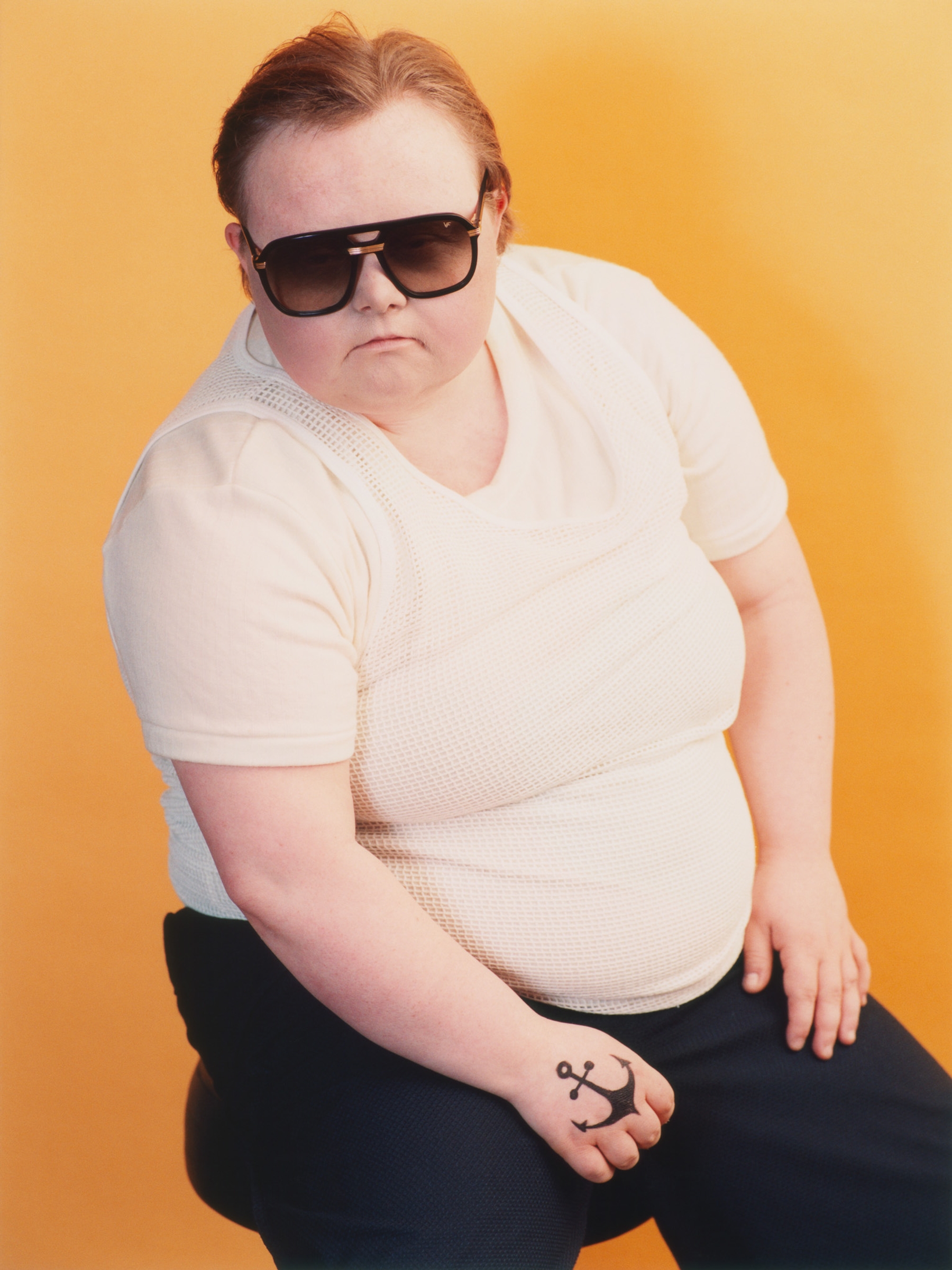 Justin Bond | T-shirt: Stylist’s own, Vest: Palace, Trousers: J.L-A.L, Sunglasses: Vintage Frames Company