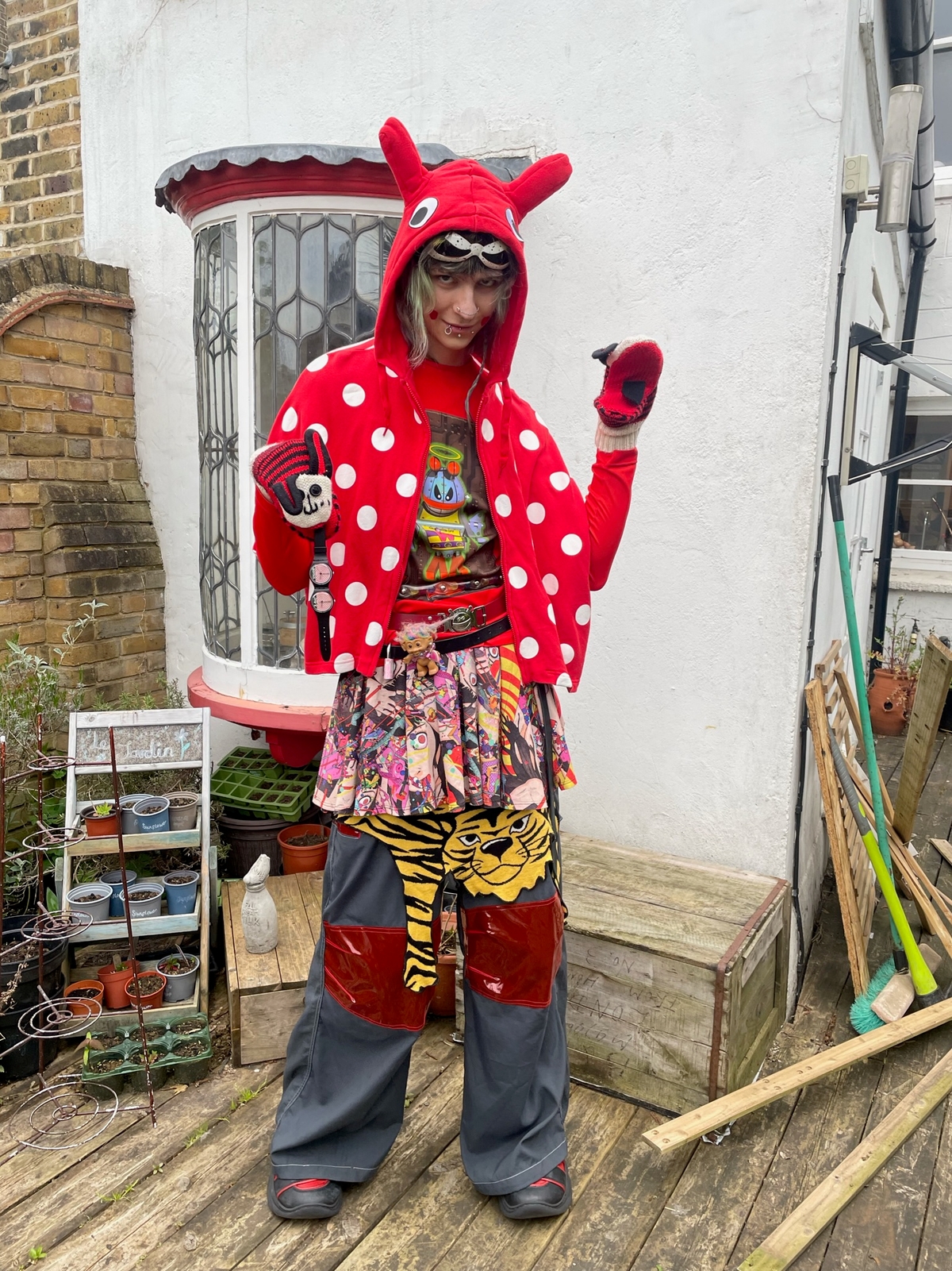 Jacket: Hyoma x b+ab - Sunglasses: Jeremy Scott x Linda Farrow - Top: Wild & Lethal Trash - Belts: Michiko Koshino, Wild & Lethal Trash, Charles Jefferey Loverboy - Gloves: Hyoma - Watch: Jeremey Scott x Swatch - Skirt: Shintaro Kago x Madame Chocolat - Tiger Skirt: Moschino Cheap and Chic - Pants: Macgear - Shoes: Swear London