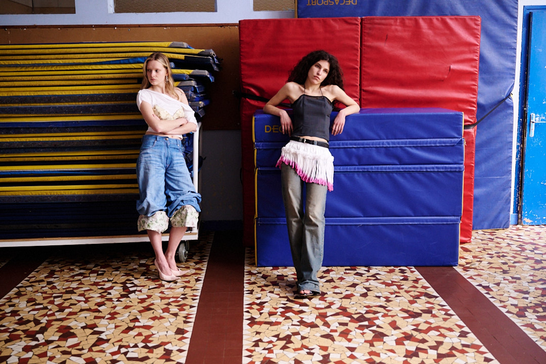 Left to right: Katya in Top & Bra Timsto, Jeans Victoire Pedron, Shoes Acne Studios, Earrings Justine Clenquet | Sofija in Top Miista, Jeans Seconda Paris, Skirt Transe Paris, Shoes Jude, Belt Acne Studios, Earrings By Goldiie




