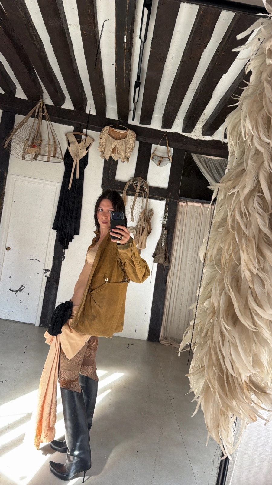 1930s mesh bra worn with antique fabrics wrapped around, 1950s US hunting jacket, theatrical bustle bow worn as a skirt, knitted leggings Junya Watanabe, shoes Shushuaddict