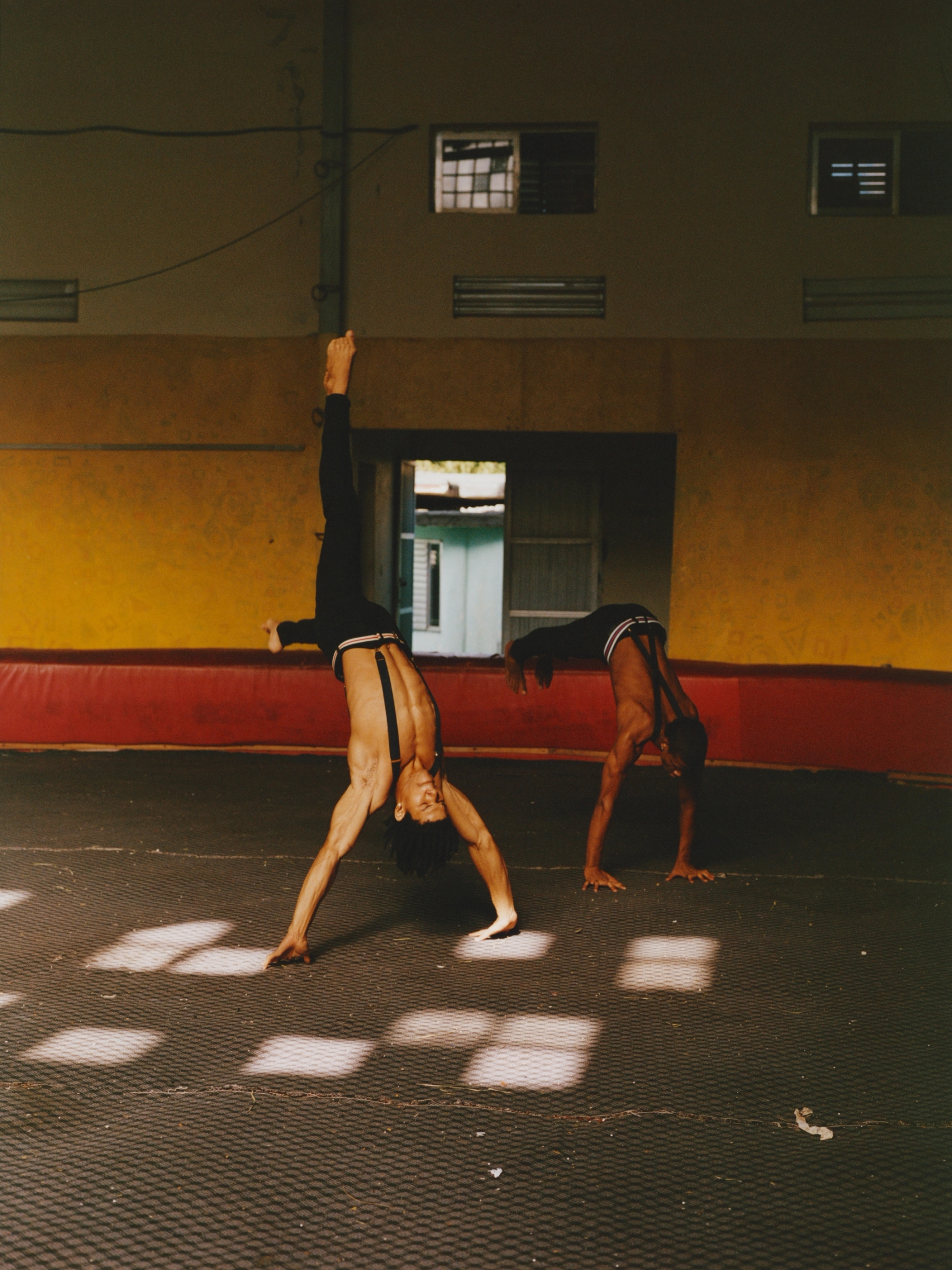 Enrique Moyé Martinez and Lexi Moyé Martinez perform backflips and during a floor acrobatics performance. In a country where resources can be limited, duo acts offer a practical alternative to large ensemble performances, requiring less equipment and space while maintaining high levels of artistry and visual impact.
