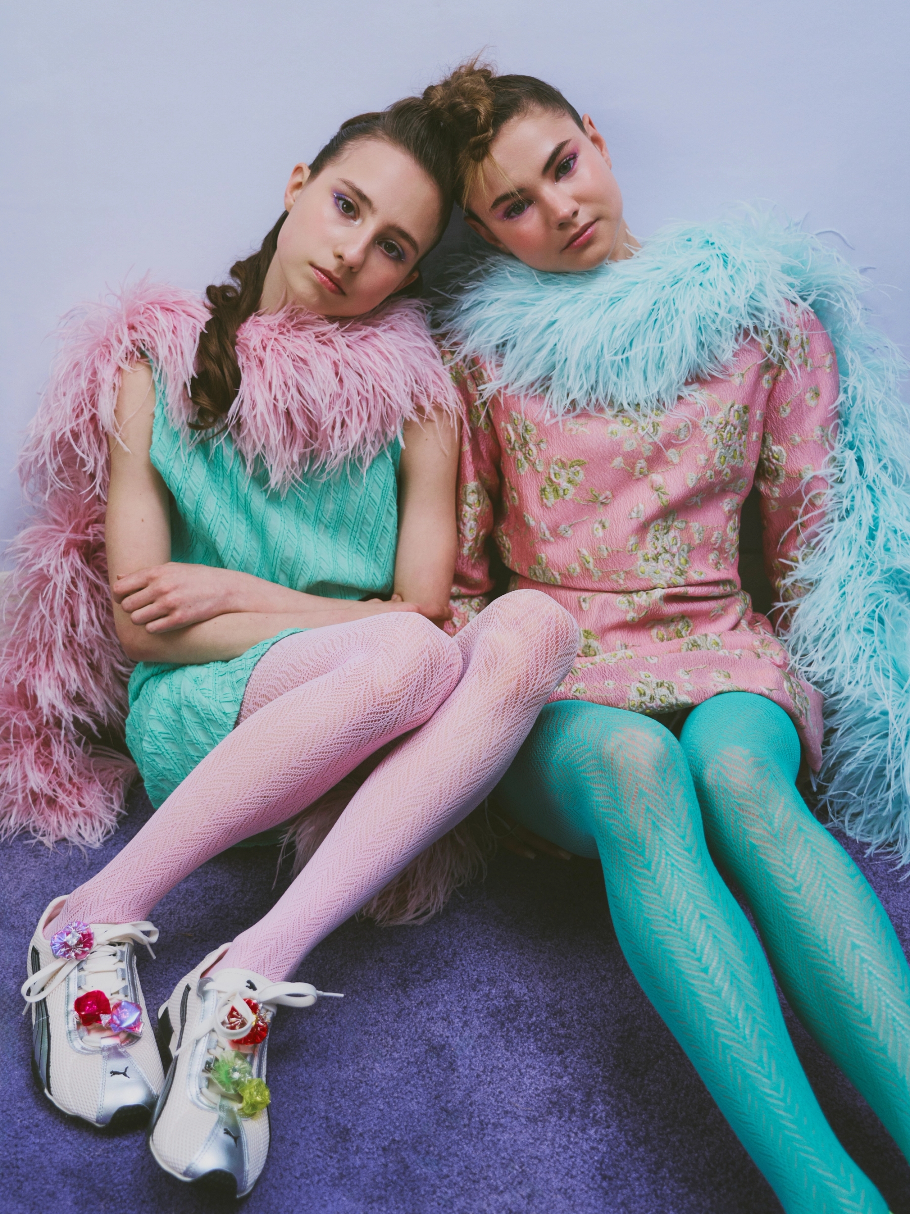 Left to right: Galya in Top & Skirt Vivetta, Shoes Puma, Feather Boa Stylist’s Own, Tights Heist, Jewellery worn on shoes XhenXhen | Lera in Dress N21, Shoes Puma, Feather Boa Stylist’s Own, Tights Heist