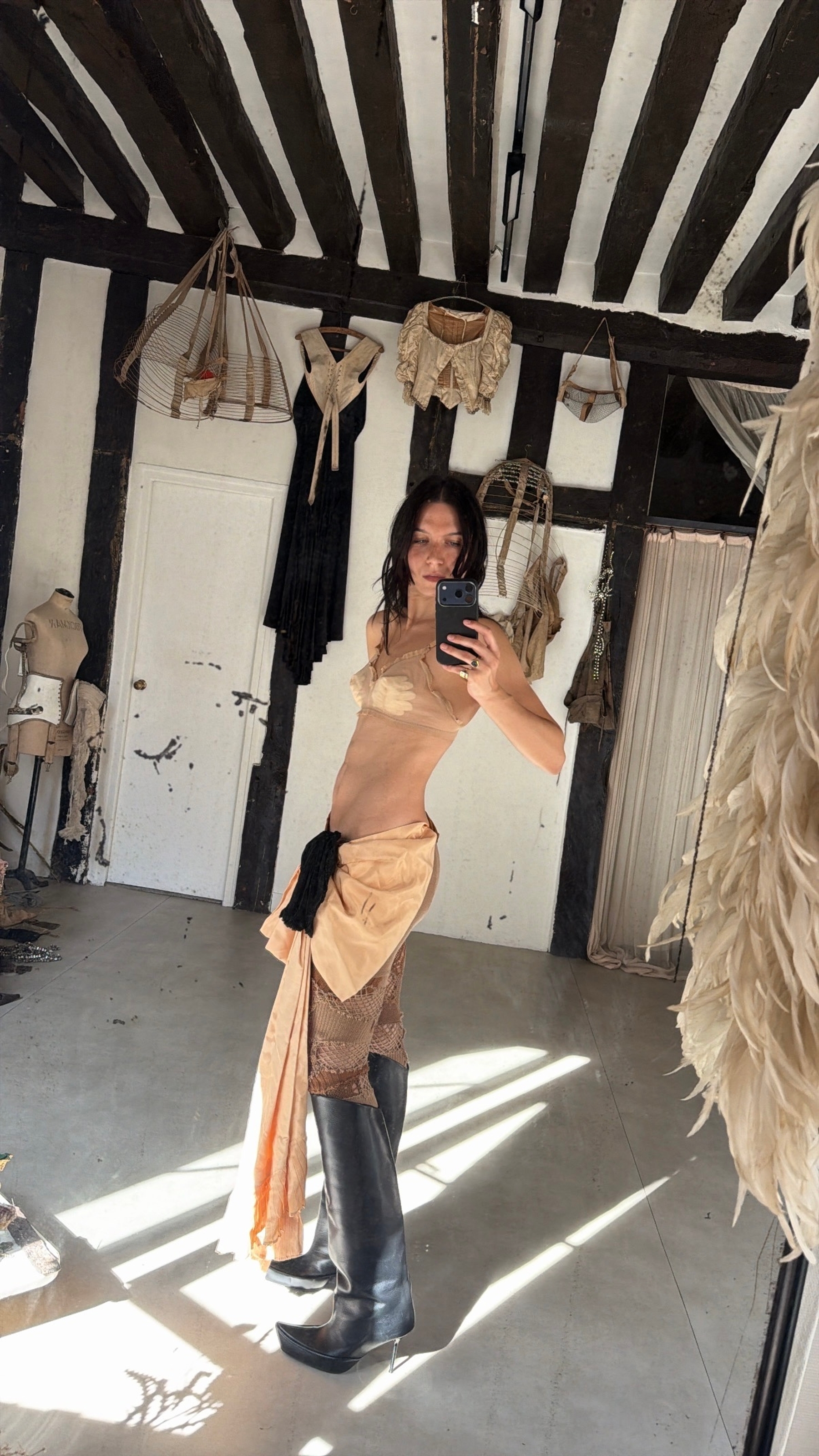 1930s mesh bra with kids wool gloves inside, theatrical bustle bow worn as a skirt, knitted leggings Junya Watanabe, shoes Shushuaddict