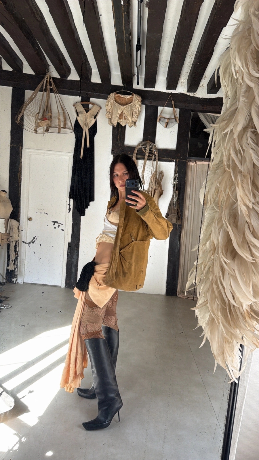 1930s mesh bra worn with antique fabrics wrapped around, 1950s US hunting jacket, theatrical bustle bow worn as a skirt, knitted leggings Junya Watanabe, shoes Shushuaddict