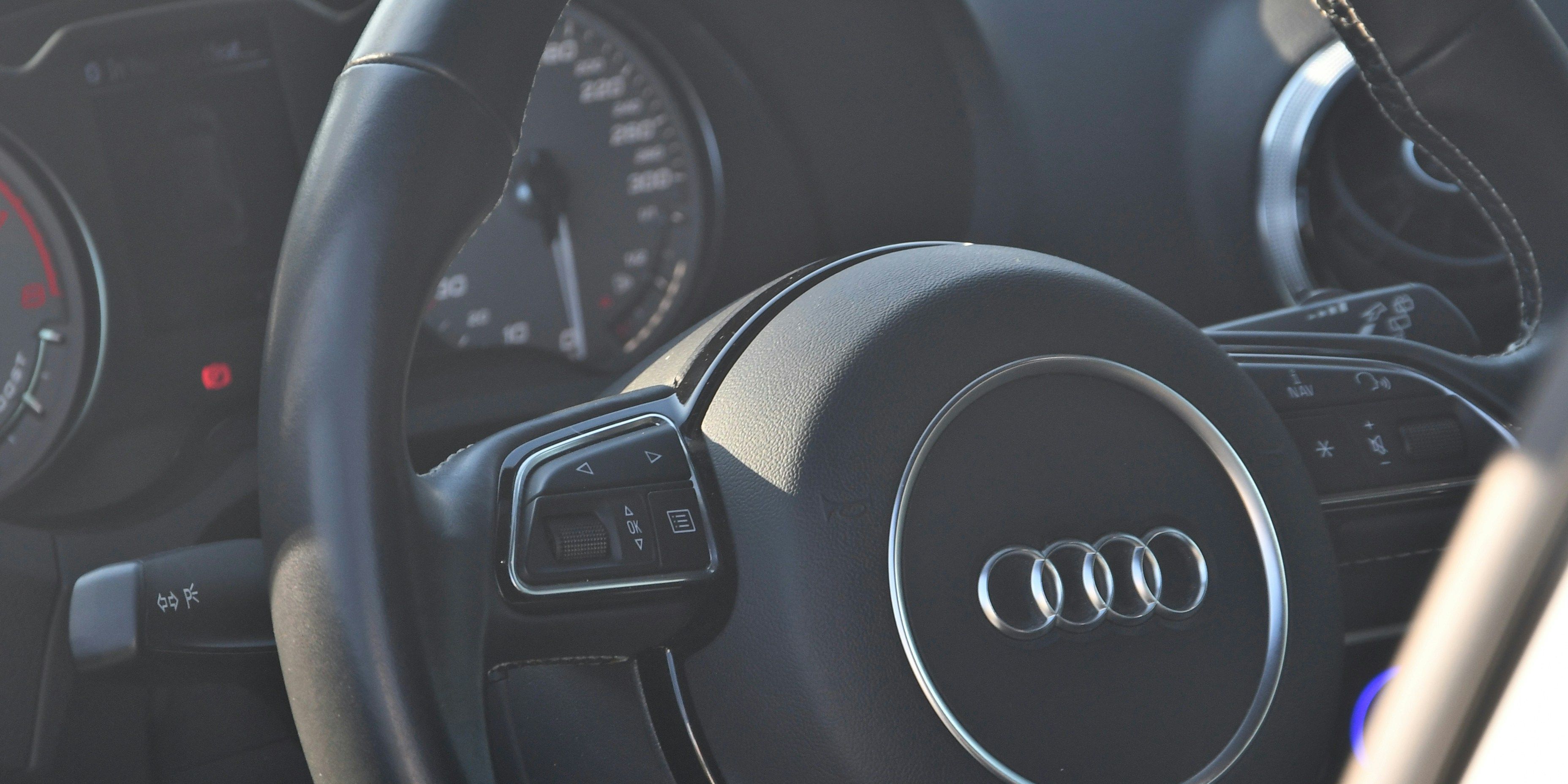 a close up of an audi steering wheel and dashboard