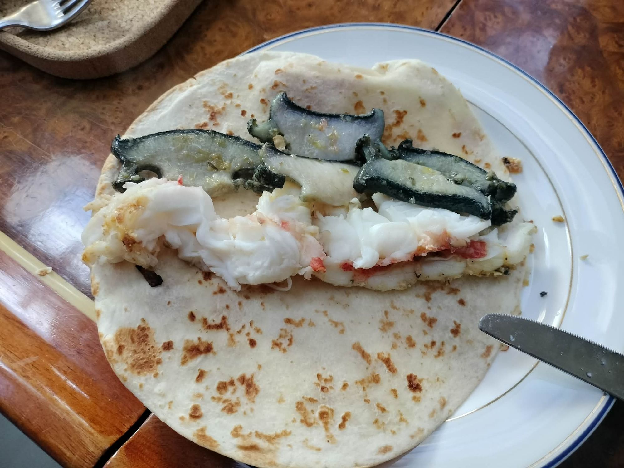 Fresh paua and crayfish on a flatbread — lunch straight from the dive
