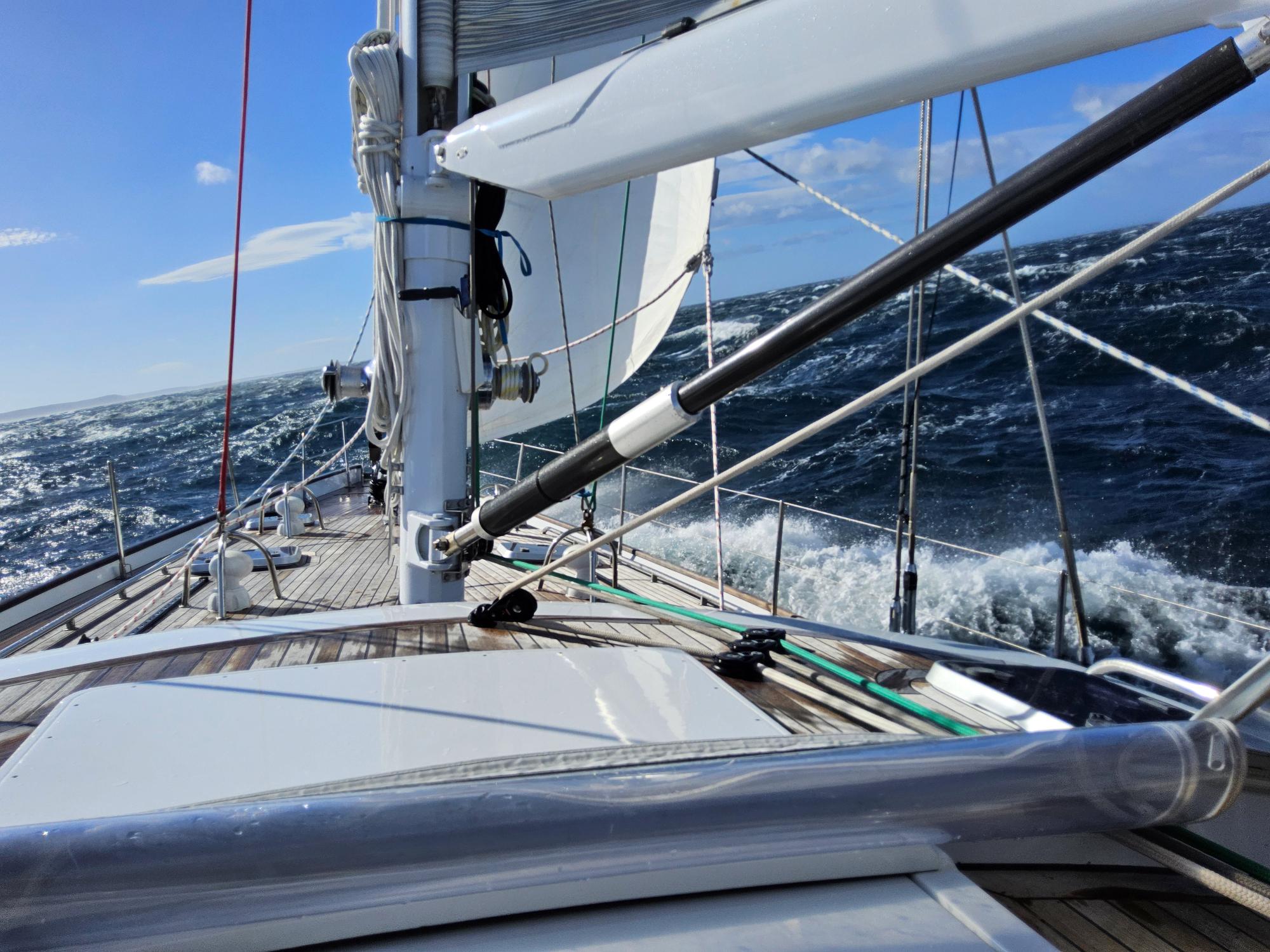 Matariki III on a broad reach in 50 knots, three reefs in the main, staysail up, flying between Port Pegasus and Oban