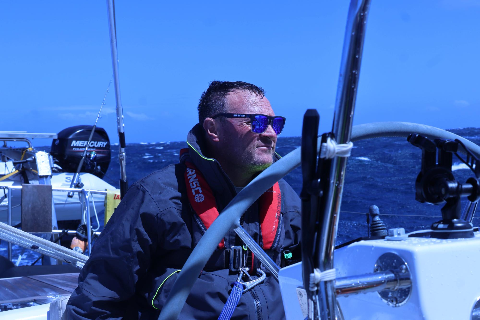 Matt at the helm scanning the horizon in heavy Tasman Sea conditions