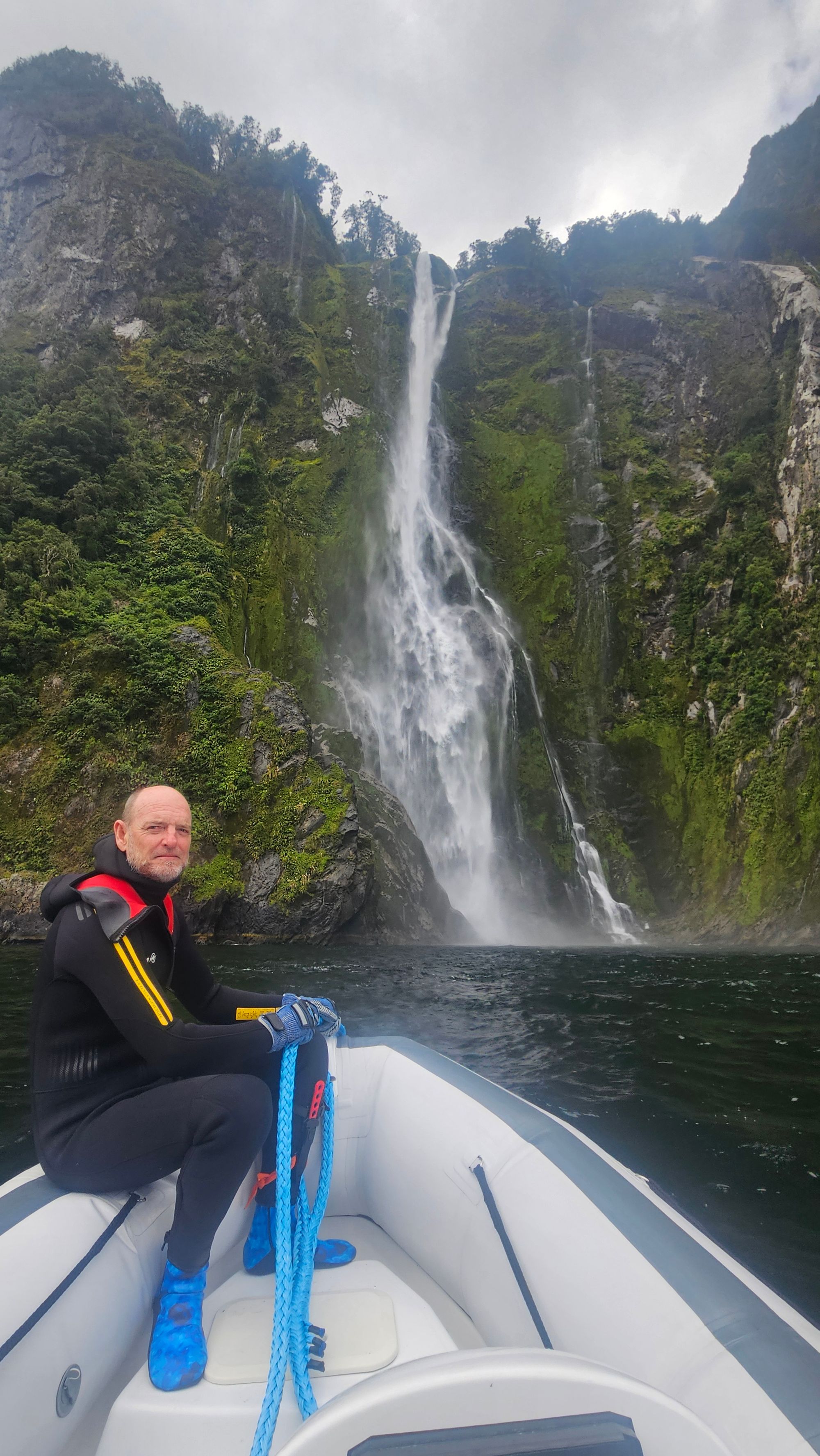 Bruce about to get wet under Stirling Falls, Milford Sound