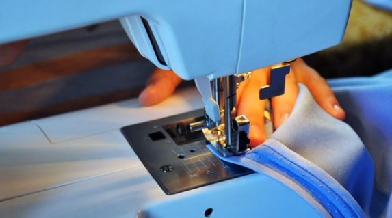 Hands on a sewing machine