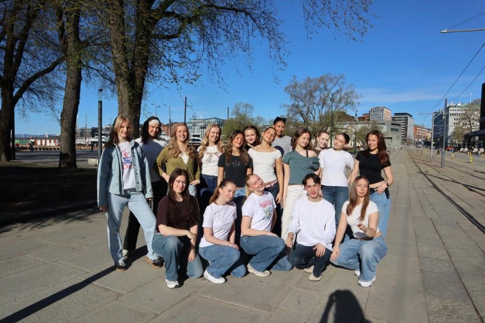 En gruppe dansestudenter samlet ved trikkeskinner