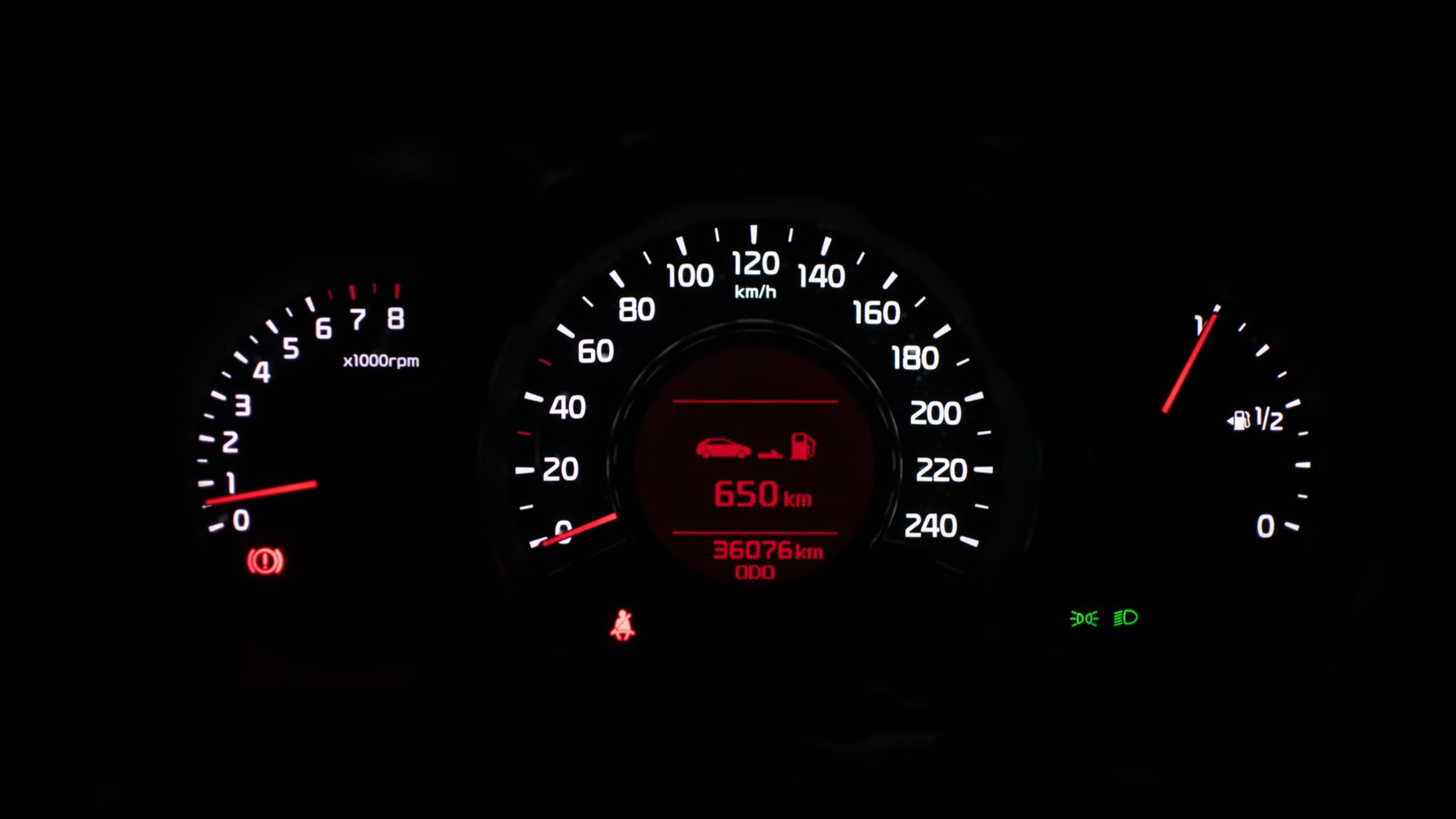 Car dashboard showing speed, RPM, fuel gauge, and 650 km remaining range.