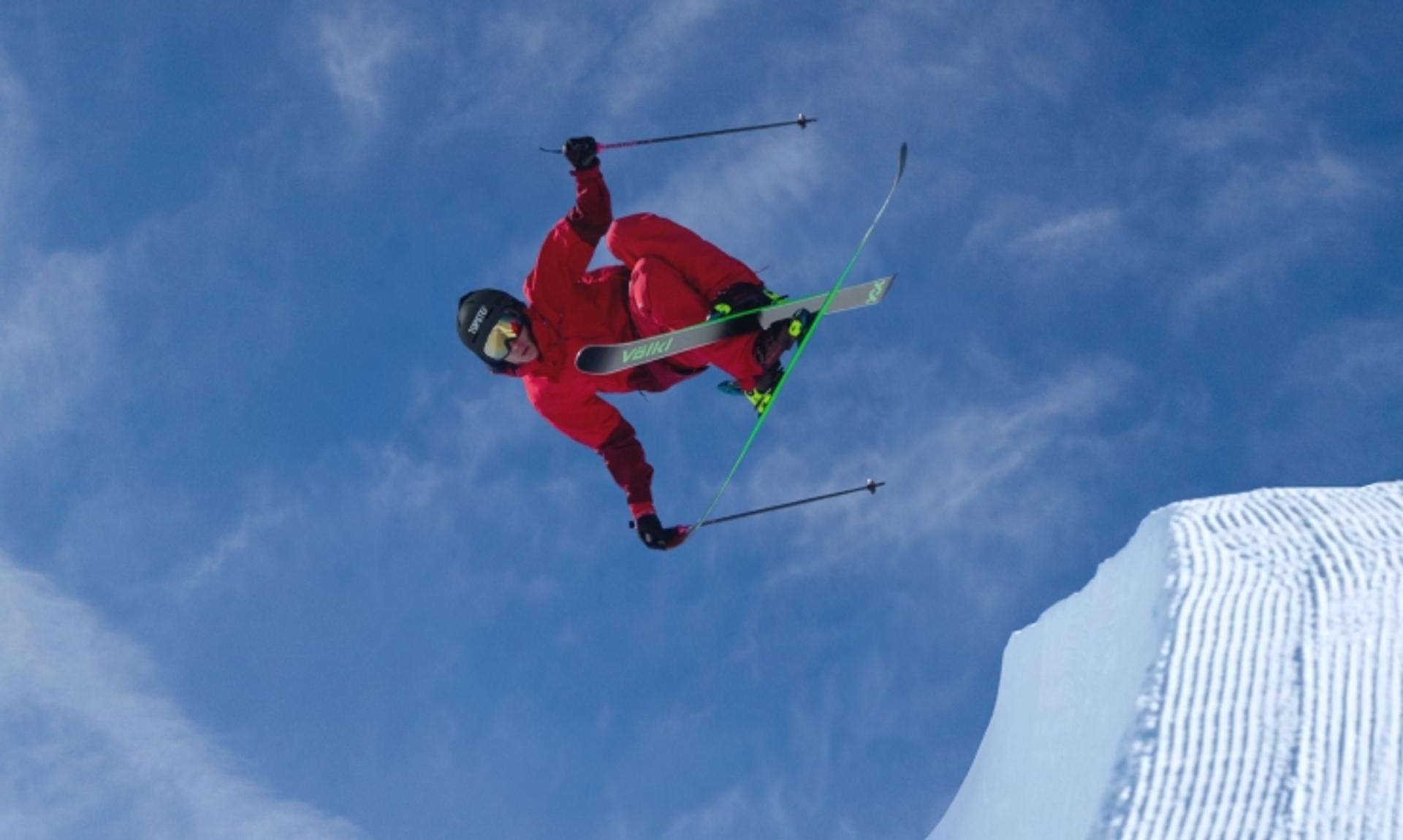 Alex Ferreira performing a midair halfpipe ski trick, demonstrating discipline, control, and execution under pressure.