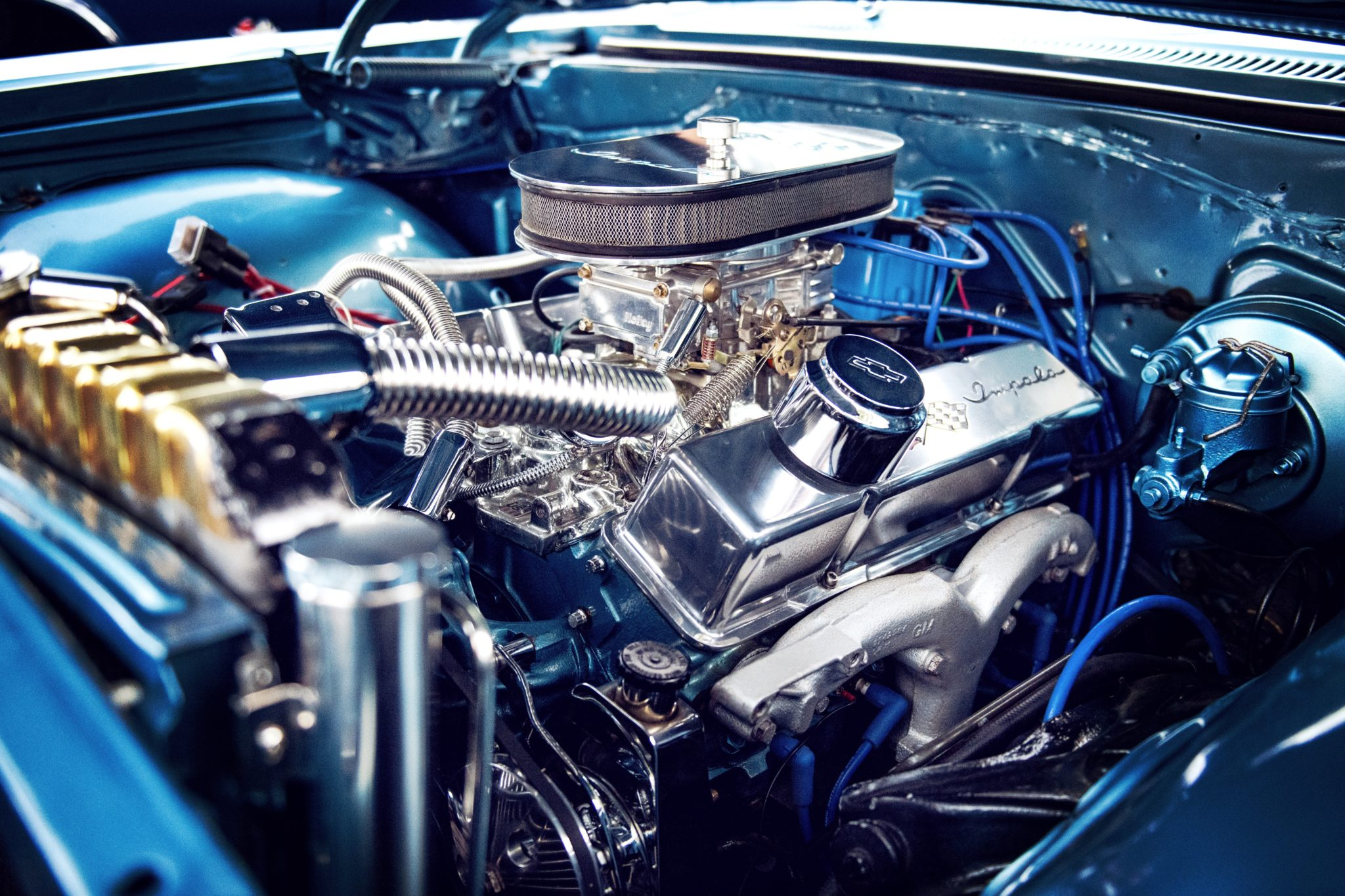Close-up of a polished engine with chrome parts and blue detailing.