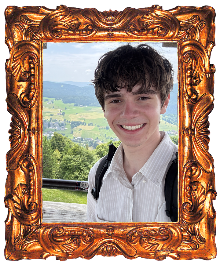 Charlie Andrade smiling on a hillside above a green valley in Germany