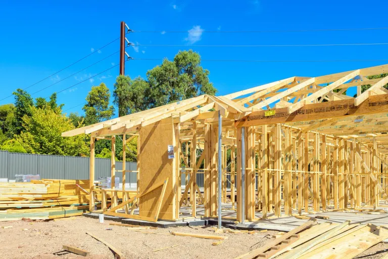 A photo of a house frame in a residential area.