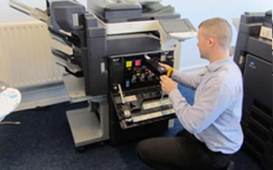 Engineer servicing an office photocopier