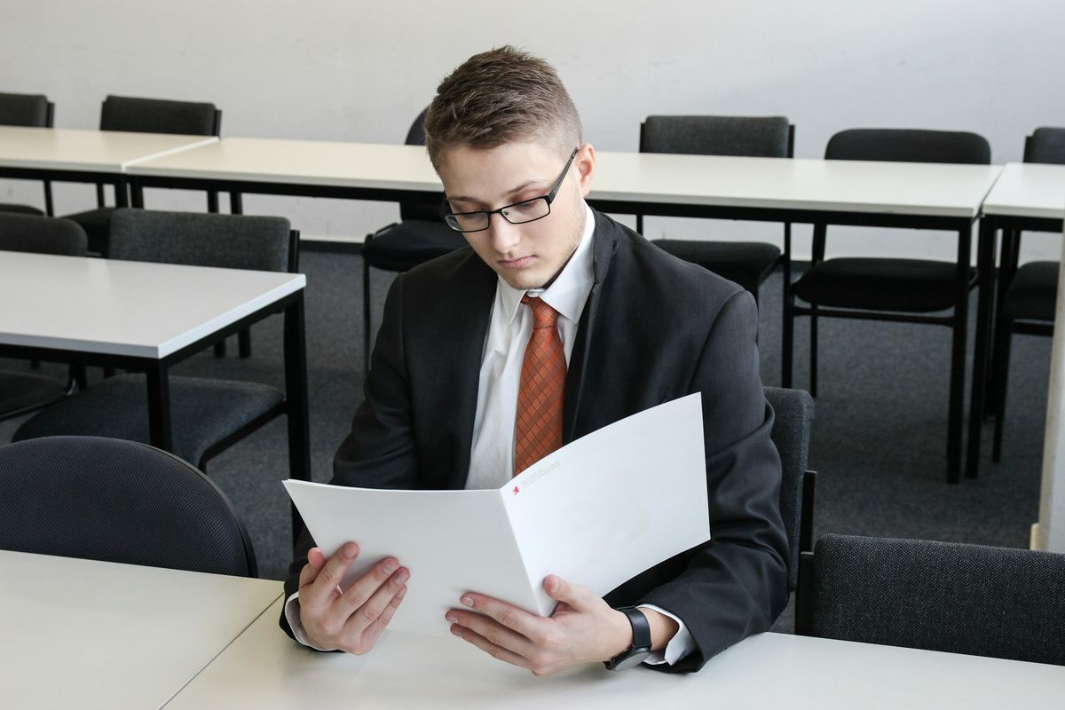 Real estate student completing documents required for a temporary real estate license