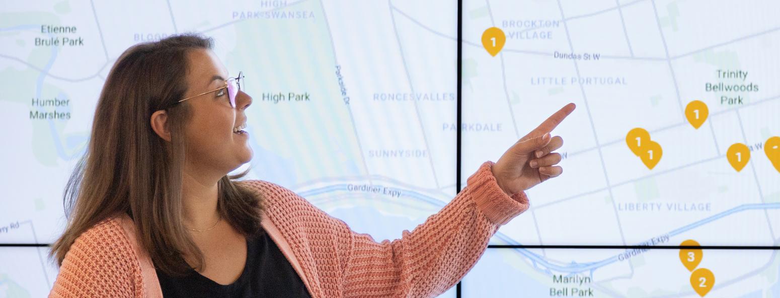 Employee presenting in front of a large screen