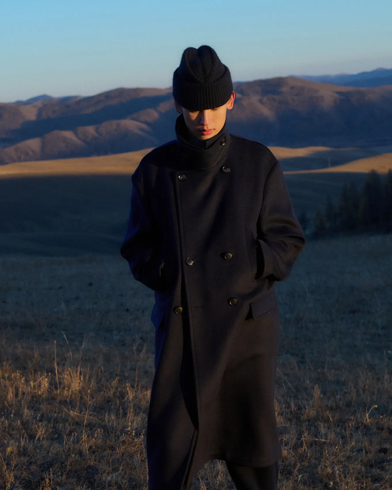 A man wearing black sailor-inspired cashmere hat and black trench cashmere coat | GOBI Cashmere