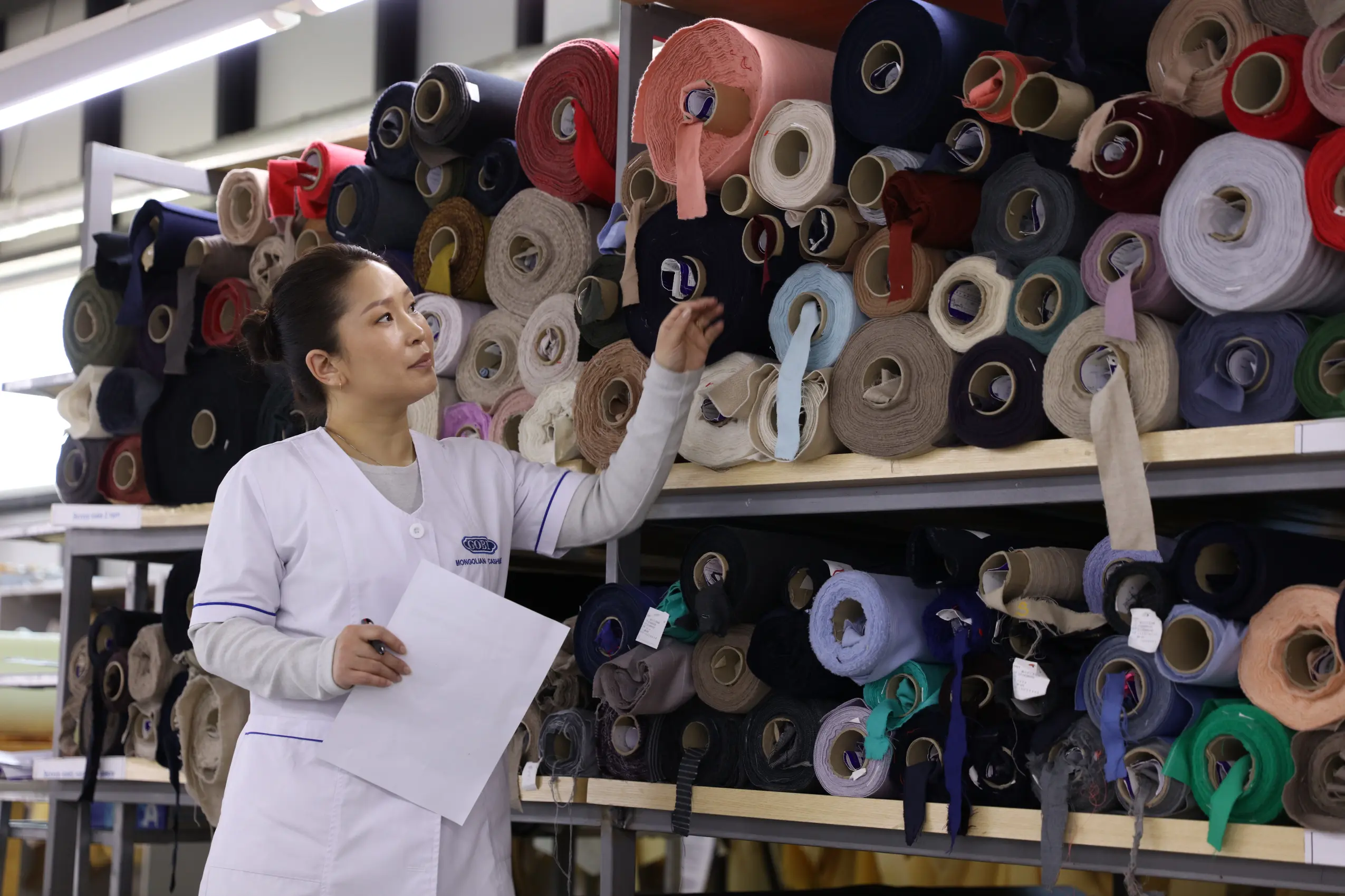 worker looking at cashmere yarns